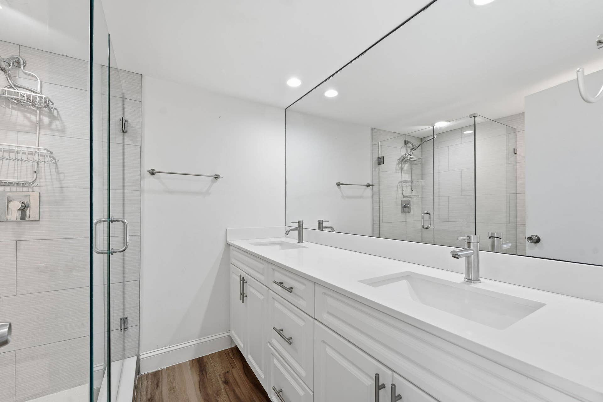 236 CHARTER Way, West Palm Beach, FL 33407 Dual vanity with integrated sinks, white cabinetry, and a full-width mirror