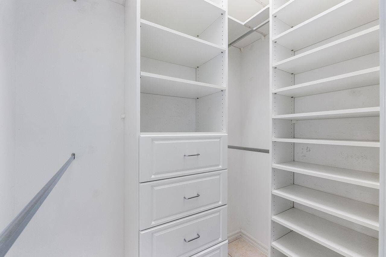 2 walk in closets in primary bedroom with built ins