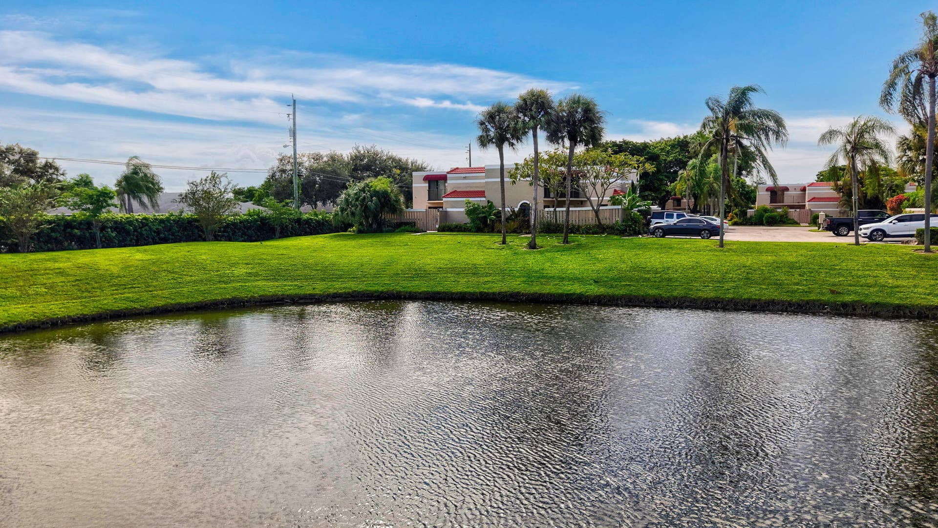 Expansive water feature with a manicured green lawn border