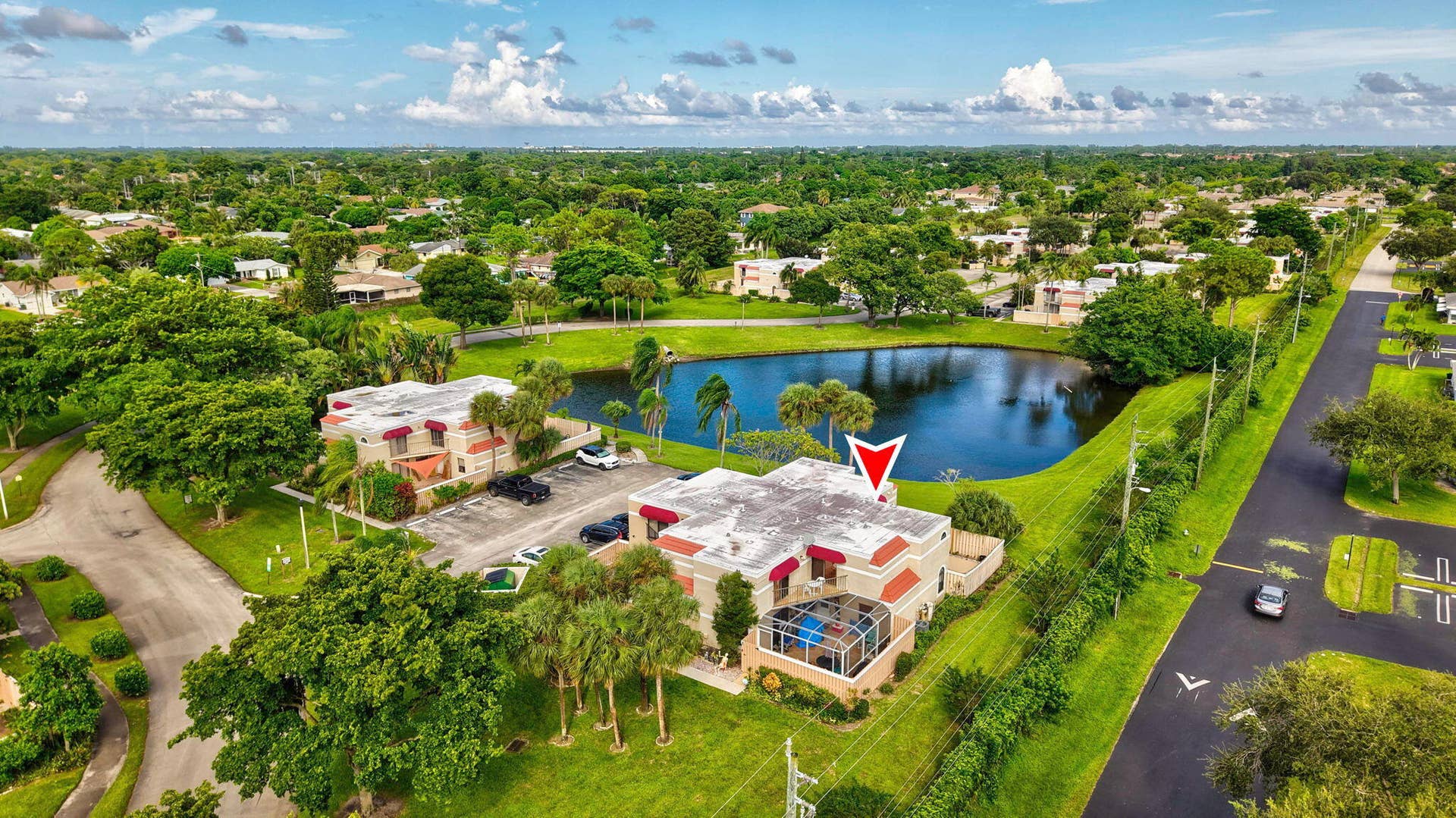 Property featuring an outdoor area, lush landscaping, and a pond