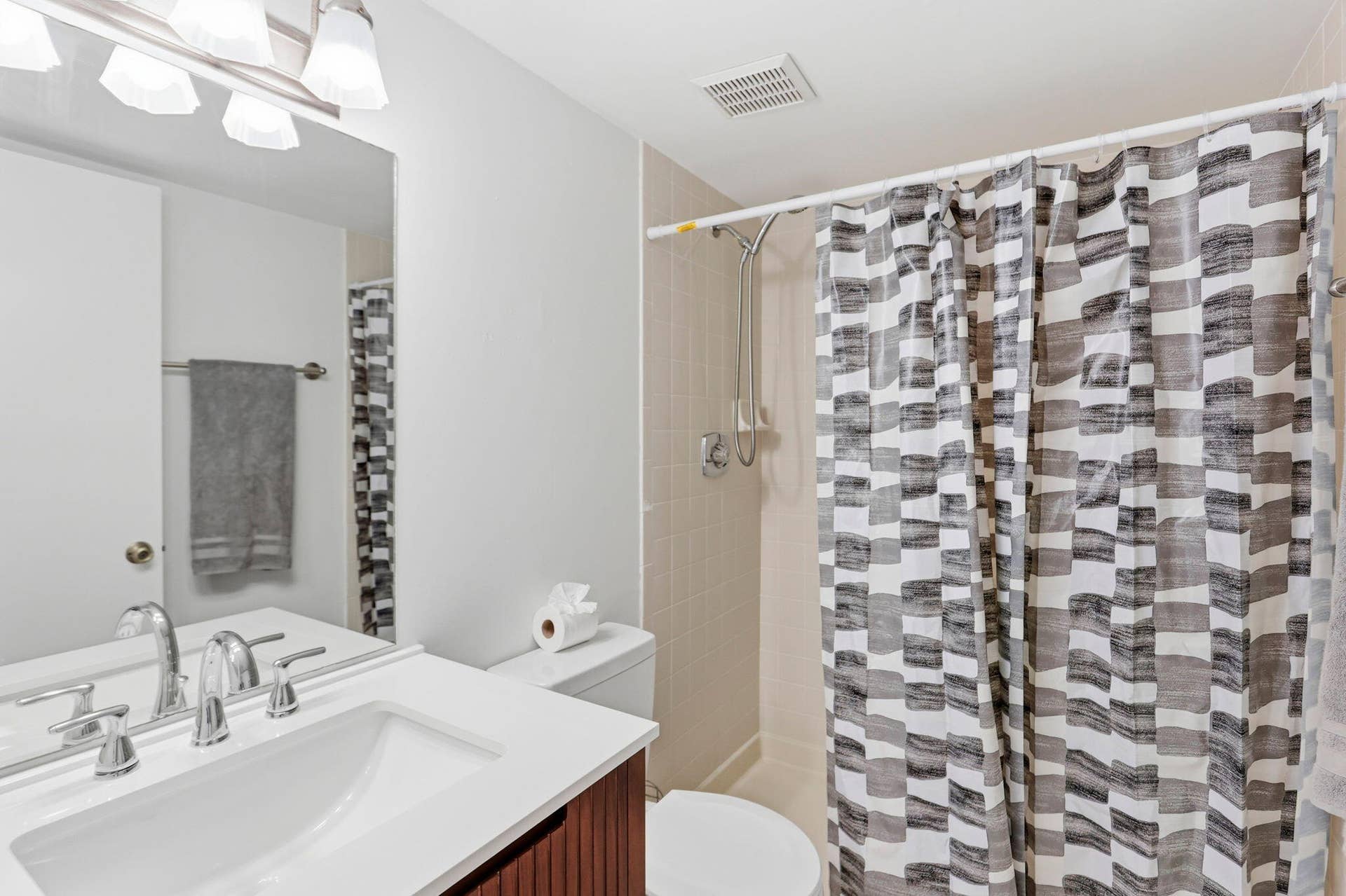 White vanity with integrated sink and chrome fixtures