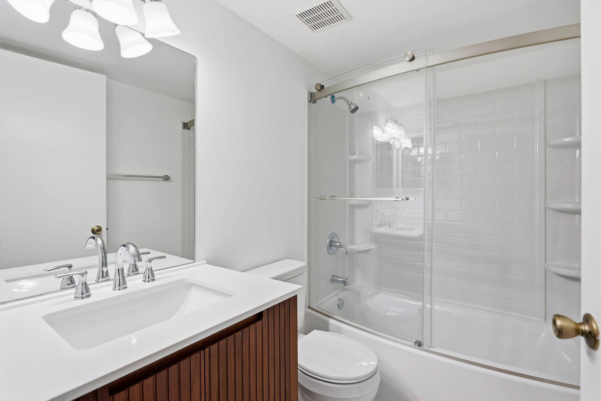White vanity with an integrated sink and chrome fixtures