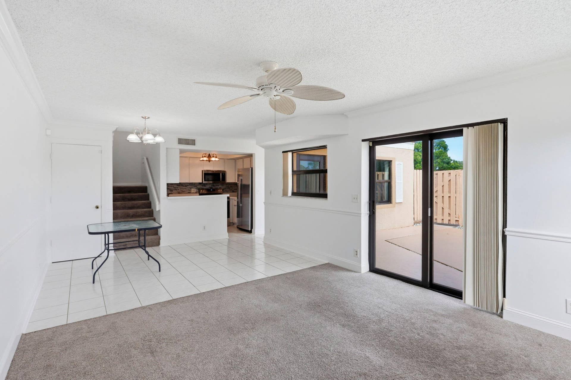Living area featuring a ceiling fan, recessed lighting, and sliding glass doors to an outdoor patio