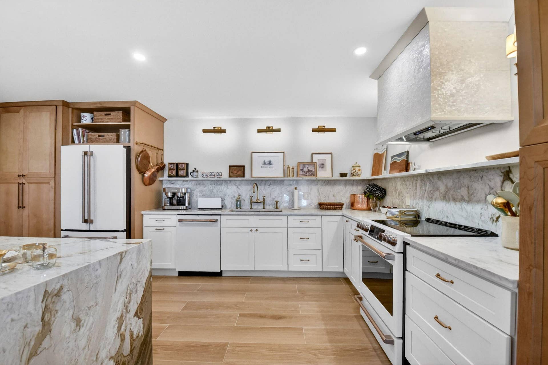 Kitchen featuring white shaker cabinetry, stone-finish countertops and backsplash, wood-finish tile flooring, a custom range hood, and recessed lighting