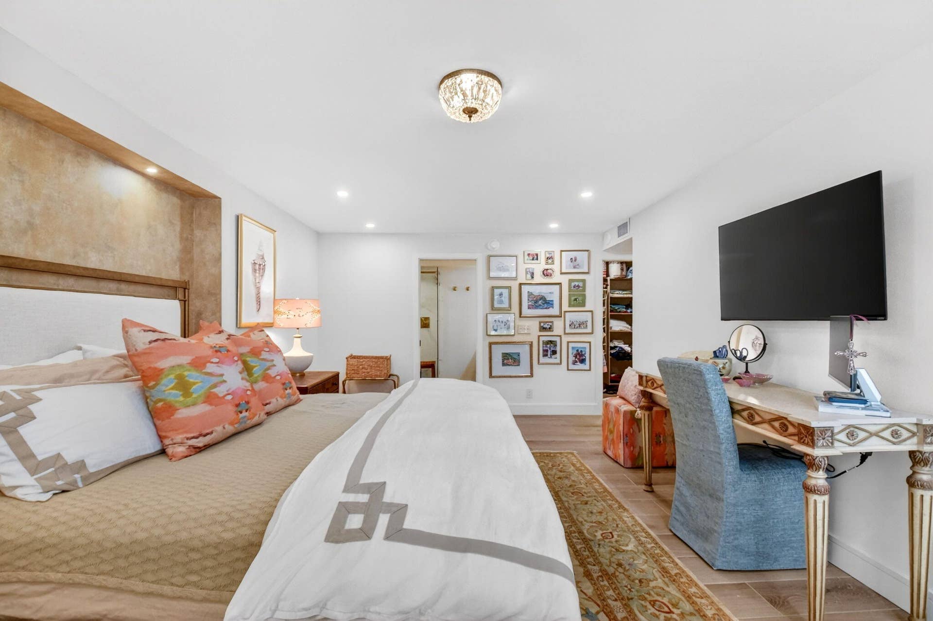 Recessed bedroom wall niche with built-in accent lighting, wood-finish flooring, and decorative semi-flush mount ceiling fixture
