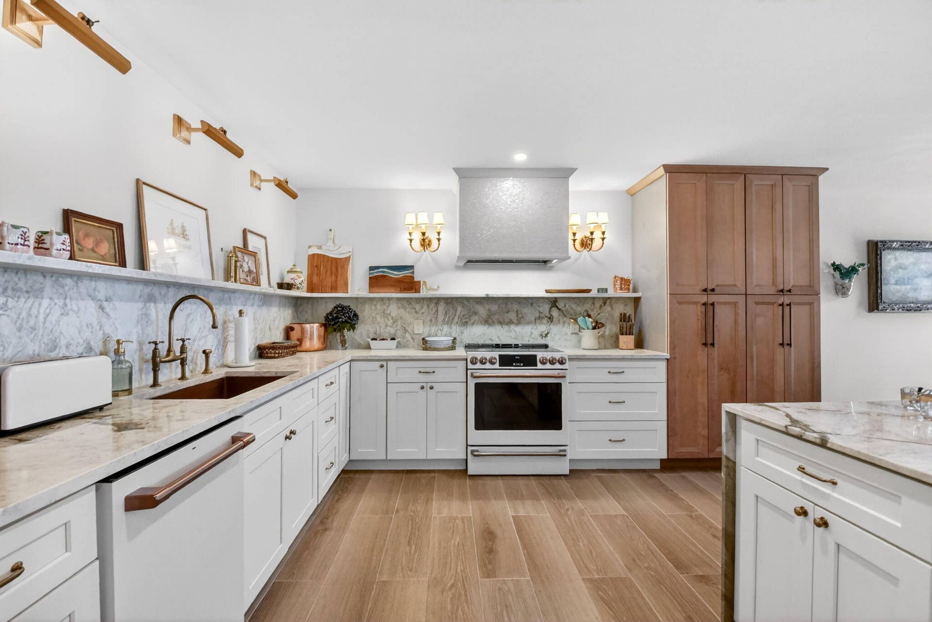 Kitchen featuring white shaker-style cabinetry, a large wood-finish pantry, stone countertops with a matching full-height backsplash, a stainless steel range hood, and wood-finish flooring
