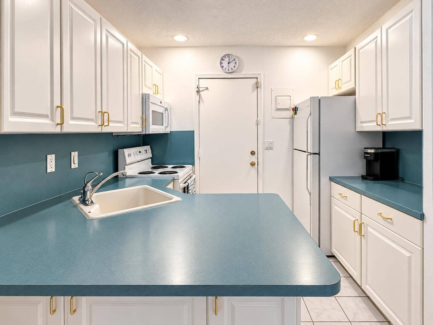 Bright Teal and White Galley Kitchen