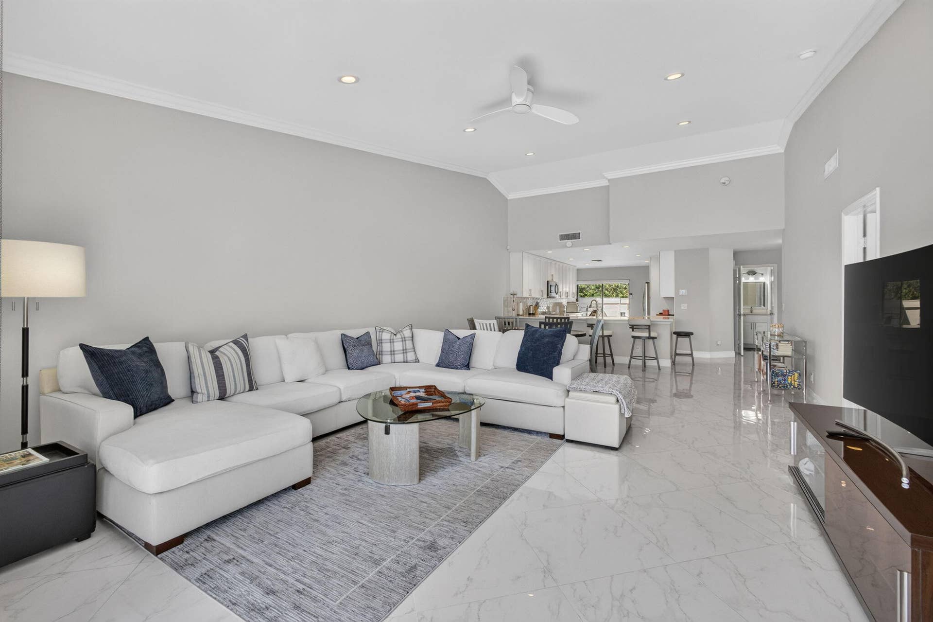 543 Prestwick Circle, Palm Beach Gardens, FL 33418 High-ceilinged room featuring large-format tile flooring, crown molding, recessed lighting, and a white ceiling fan