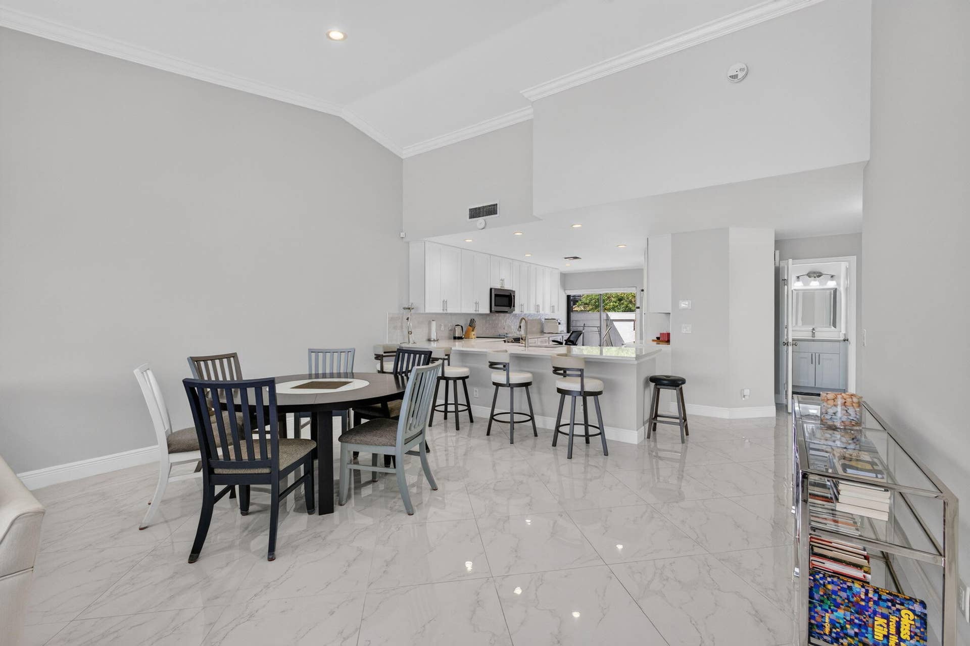543 Prestwick Circle, Palm Beach Gardens, FL 33418 Vaulted ceilings, large-format tile flooring, recessed lighting, and a kitchen peninsula with integrated cabinetry