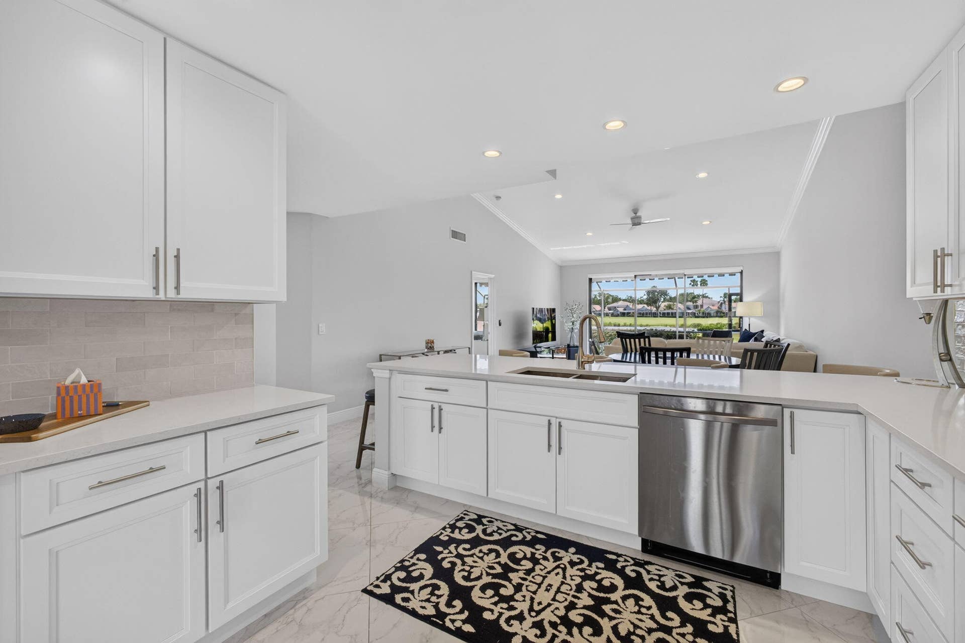 543 Prestwick Circle, Palm Beach Gardens, FL 33418 Kitchen featuring white cabinetry, quartz countertops, tile backsplash, stainless steel dishwasher, and recessed lighting