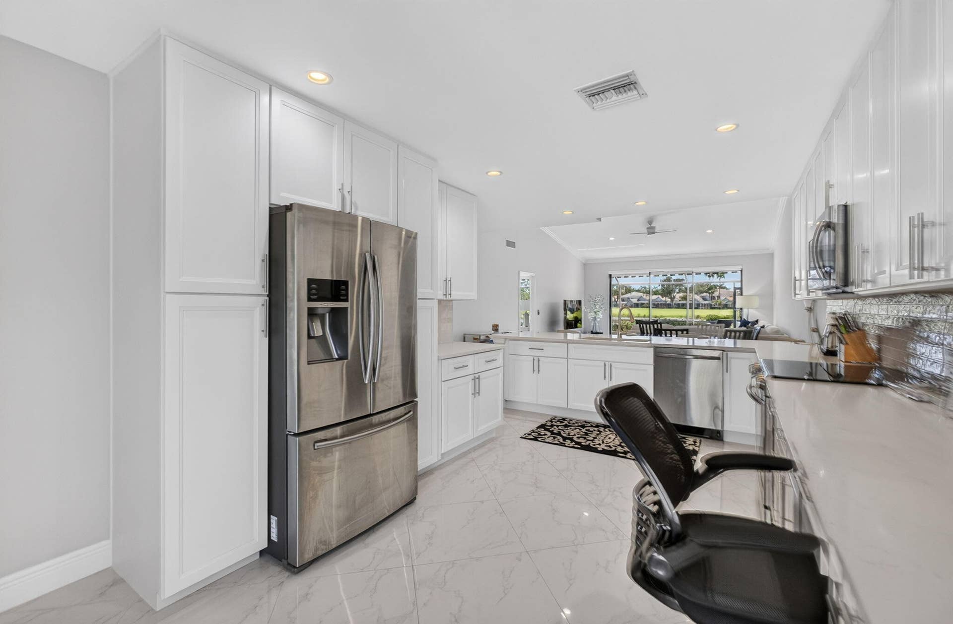 543 Prestwick Circle, Palm Beach Gardens, FL 33418 Kitchen featuring white cabinetry, quartz countertops, stainless steel appliances, recessed lighting, and large-format tile flooring
