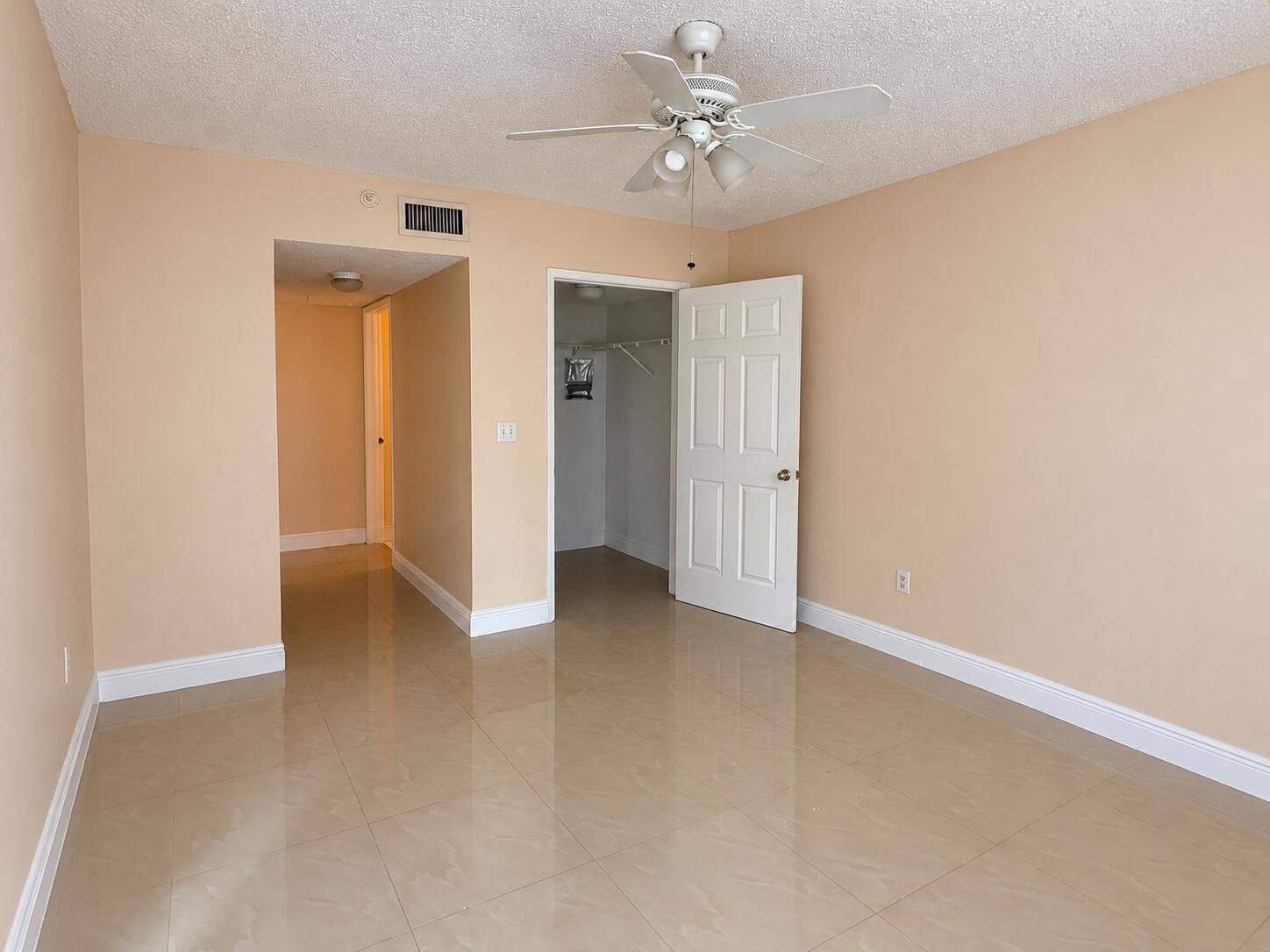 Empty Beige Room with Open Closet and Ce