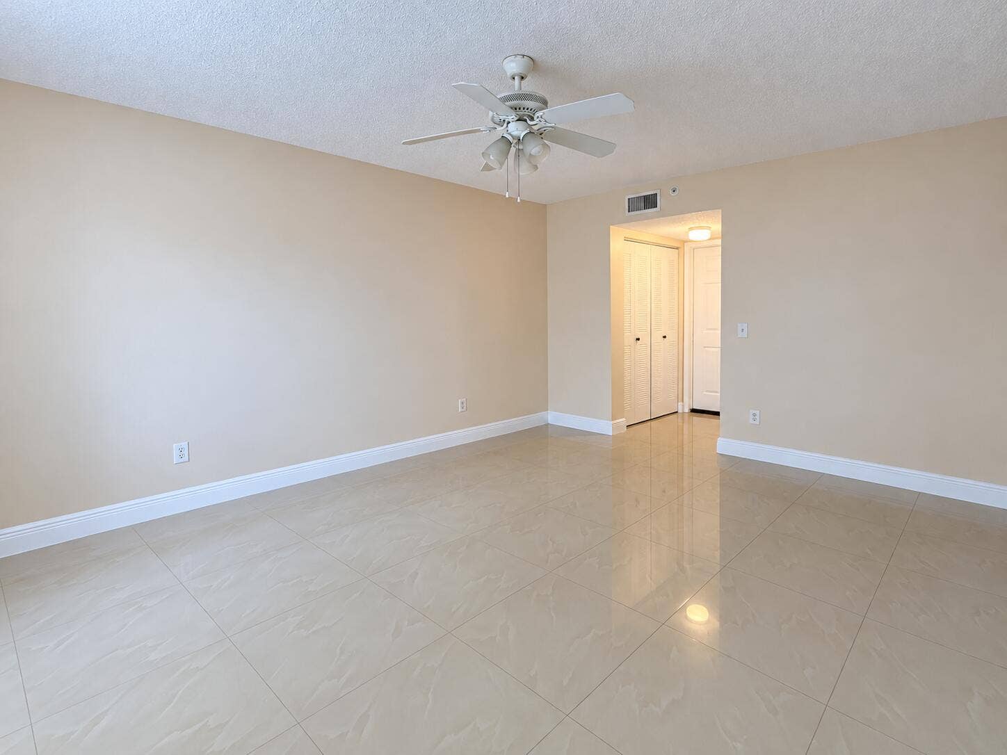 Empty Beige Room with Ceiling Fan and Al