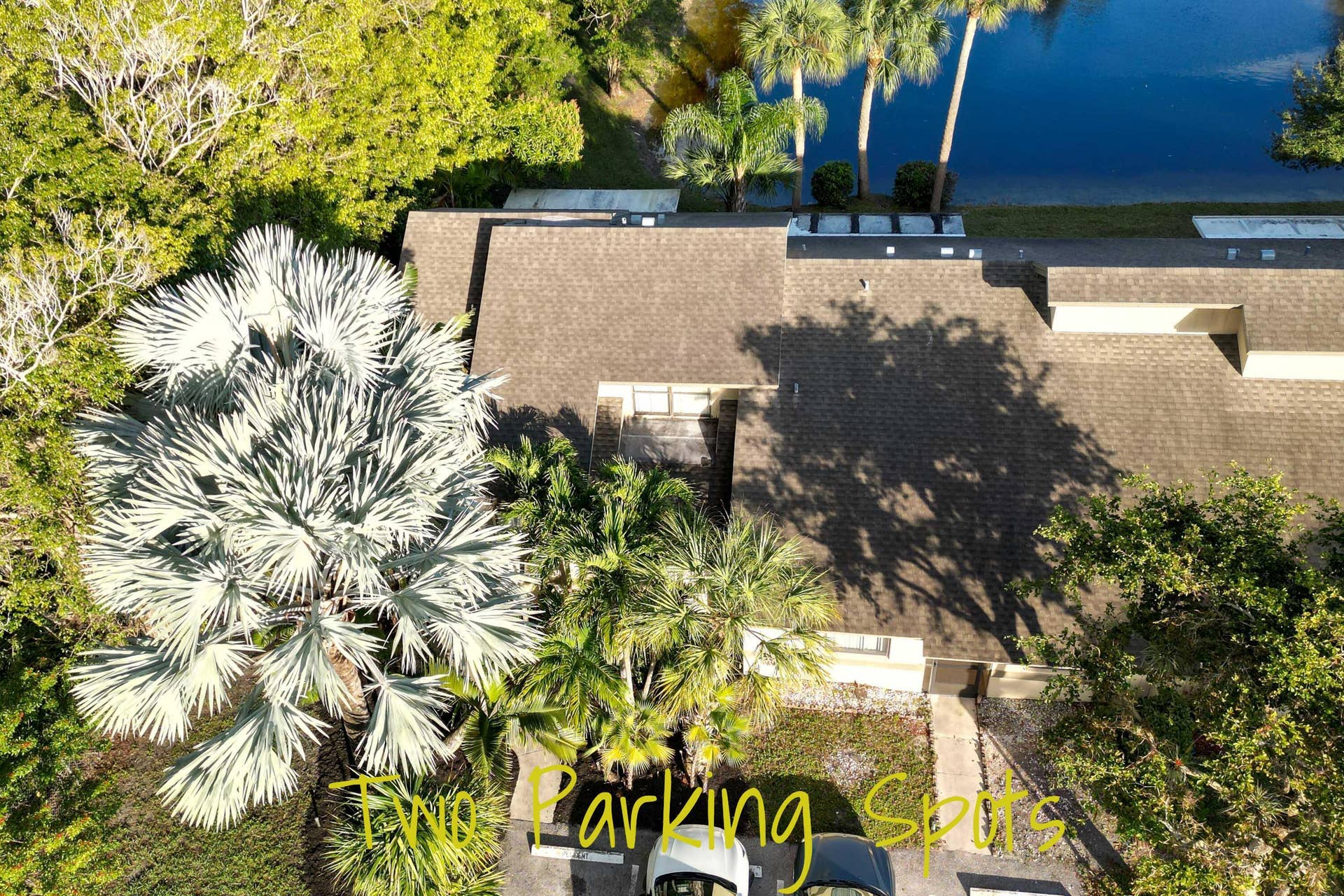 Asphalt shingle roofing, mature landscaping, and waterfront location