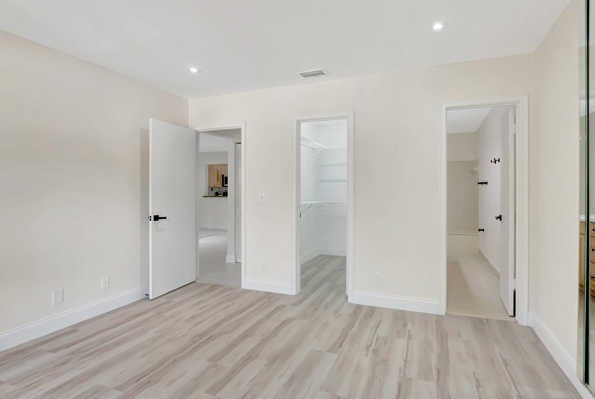 Wood-finish flooring, recessed lighting, and built-in closet shelving
