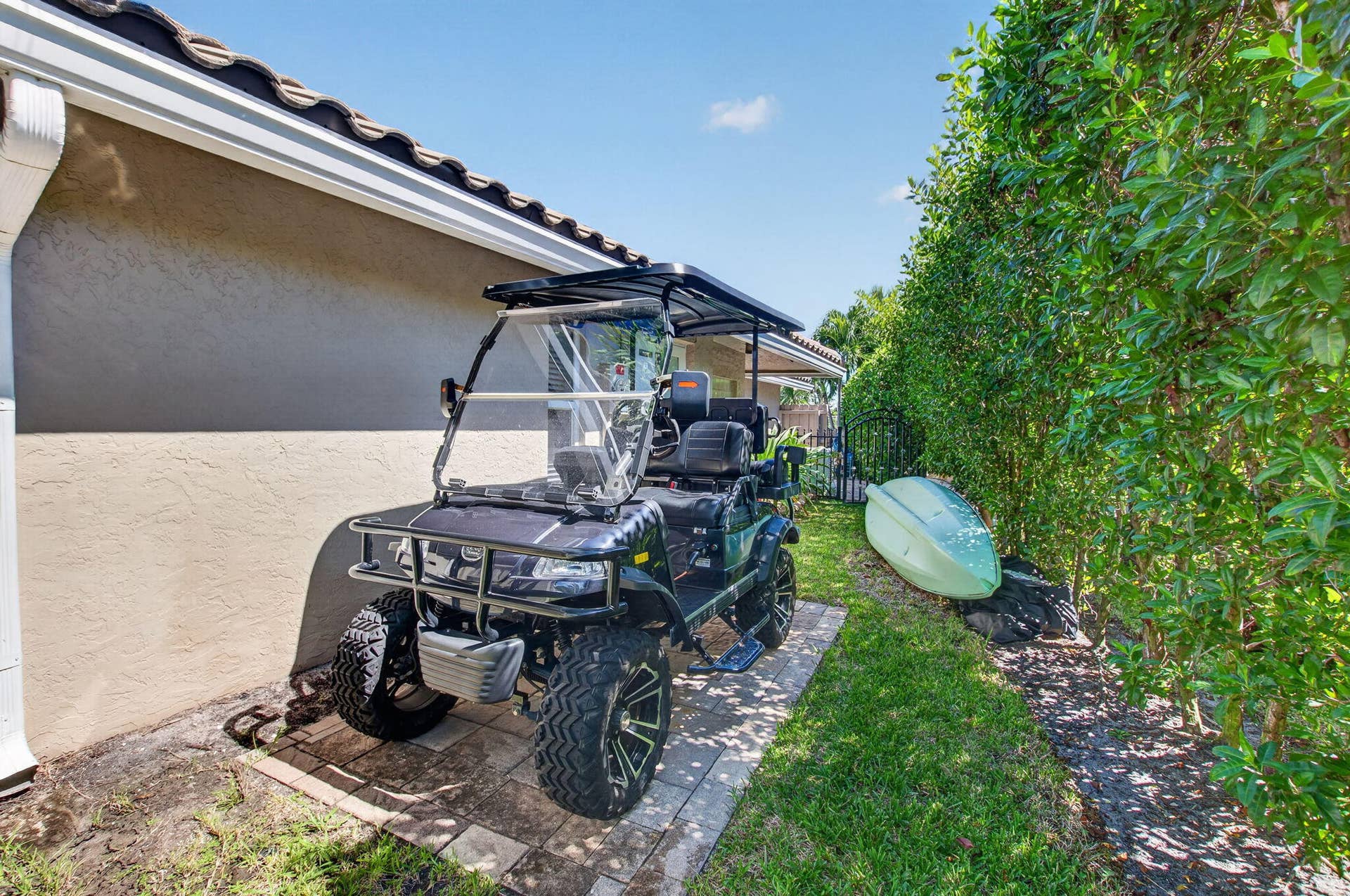 2321 SPANISH Trail, Delray Beach, FL 33483 SIDE YARD PATH WITH GOLF CART PARKING