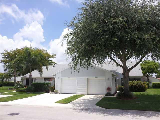 Charming single-story residence with a bright white exterior and attached two-car garage