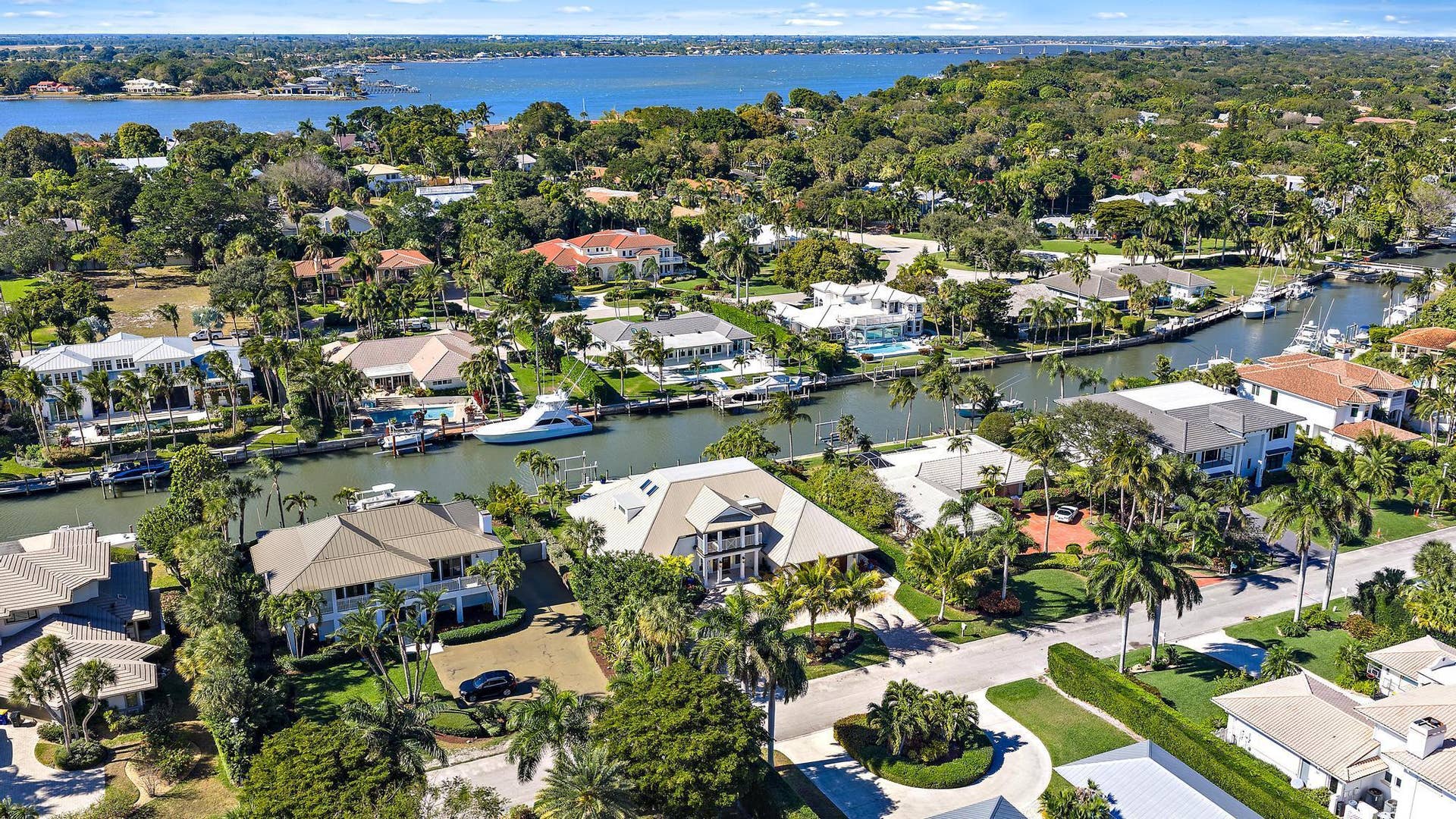 Aerial perspective of waterfront properties featuring deep-water canal access, private boat docks, and established coastal vegetation