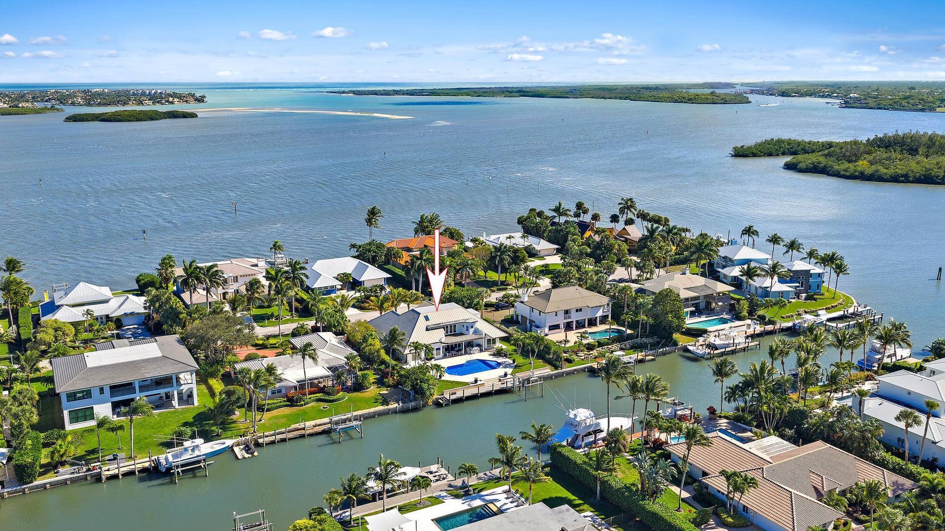 Waterfront property featuring a private boat dock, swimming pool, and direct canal access