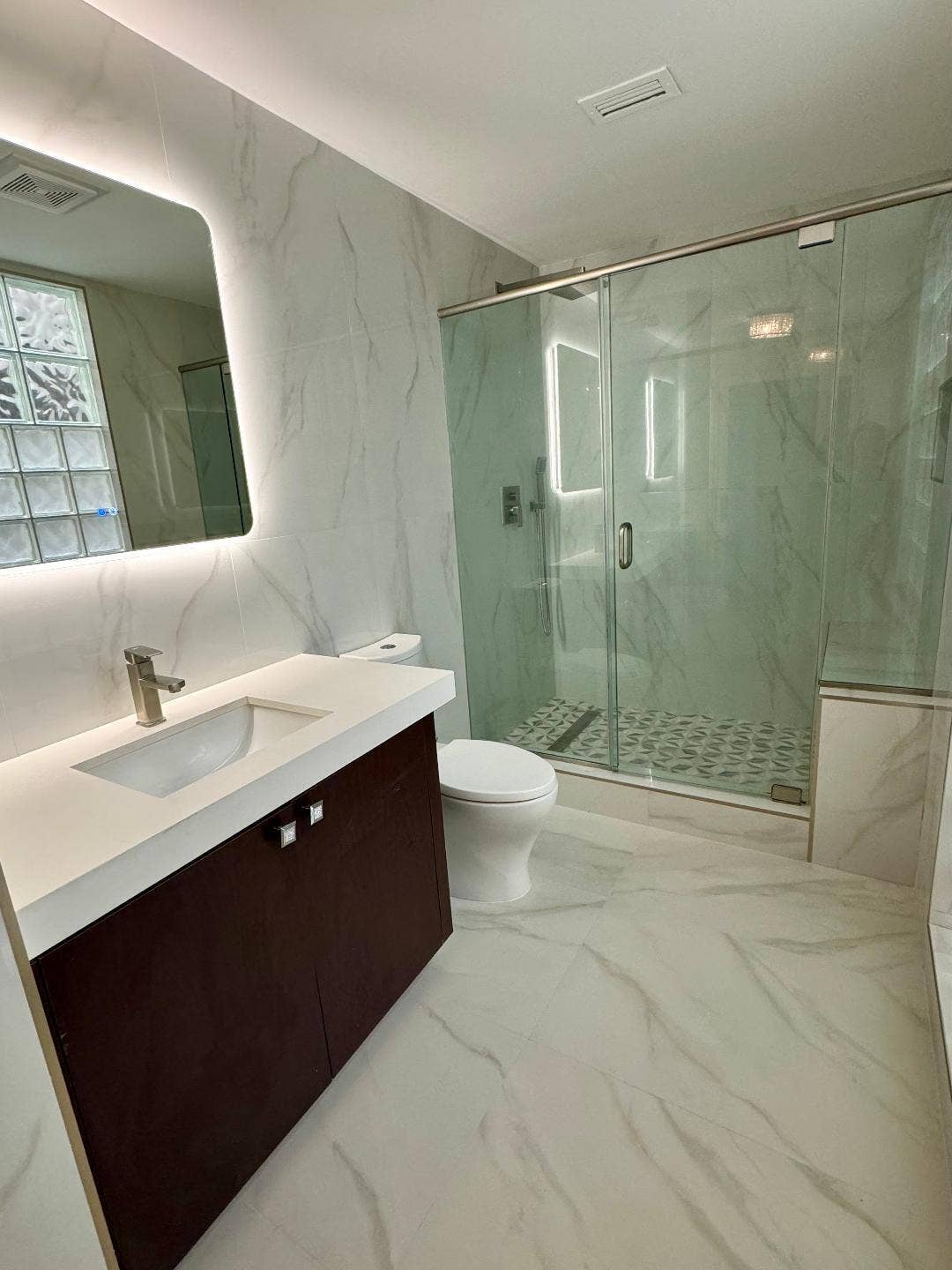1127 BOCA COVE Lane, Highland Beach, FL 33487 Floating vanity with a white quartz countertop and integrated sink