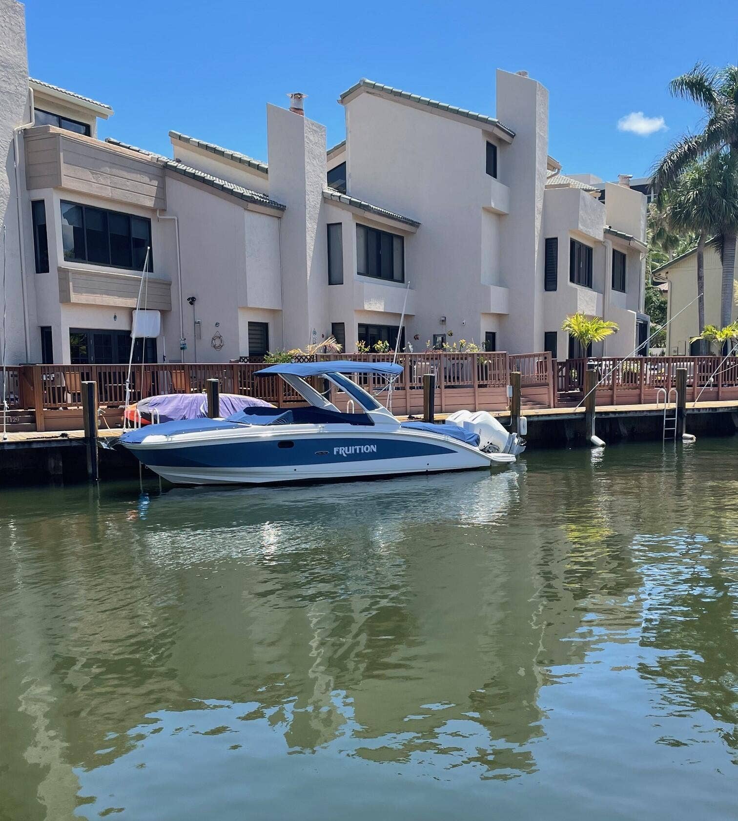1127 BOCA COVE Lane, Highland Beach, FL 33487 Waterfront property featuring a private boat dock, wood decking, and stucco exterior