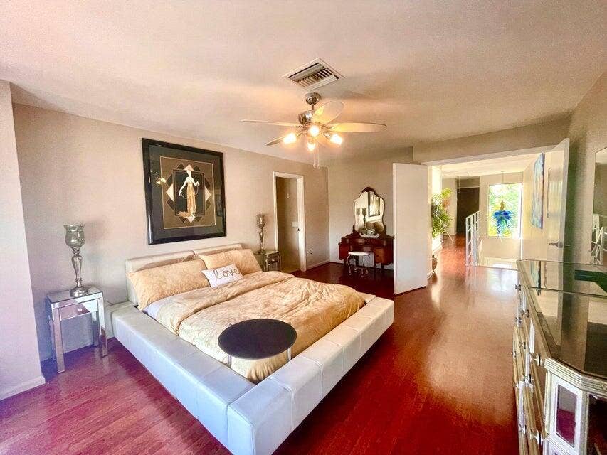 1127 BOCA COVE Lane, Highland Beach, FL 33487 Wood-finish flooring throughout, ceiling fan with integrated lighting, and neutral wall tones