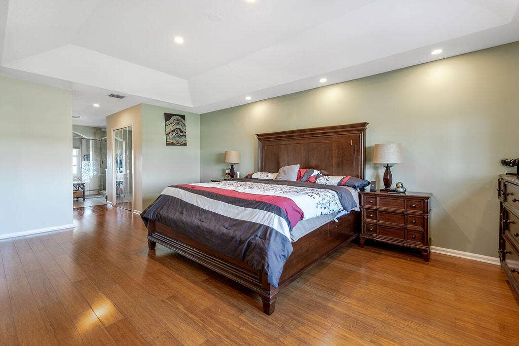 1233 Avondale Lane, West Palm Beach, FL 33409 Tray ceiling, wood-finish flooring, and recessed lighting