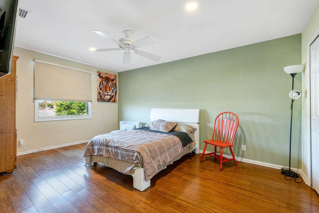 1233 Avondale Lane, West Palm Beach, FL 33409 Wood-finish flooring, ceiling fan with integrated lighting, recessed lighting, and a window with a roller shade