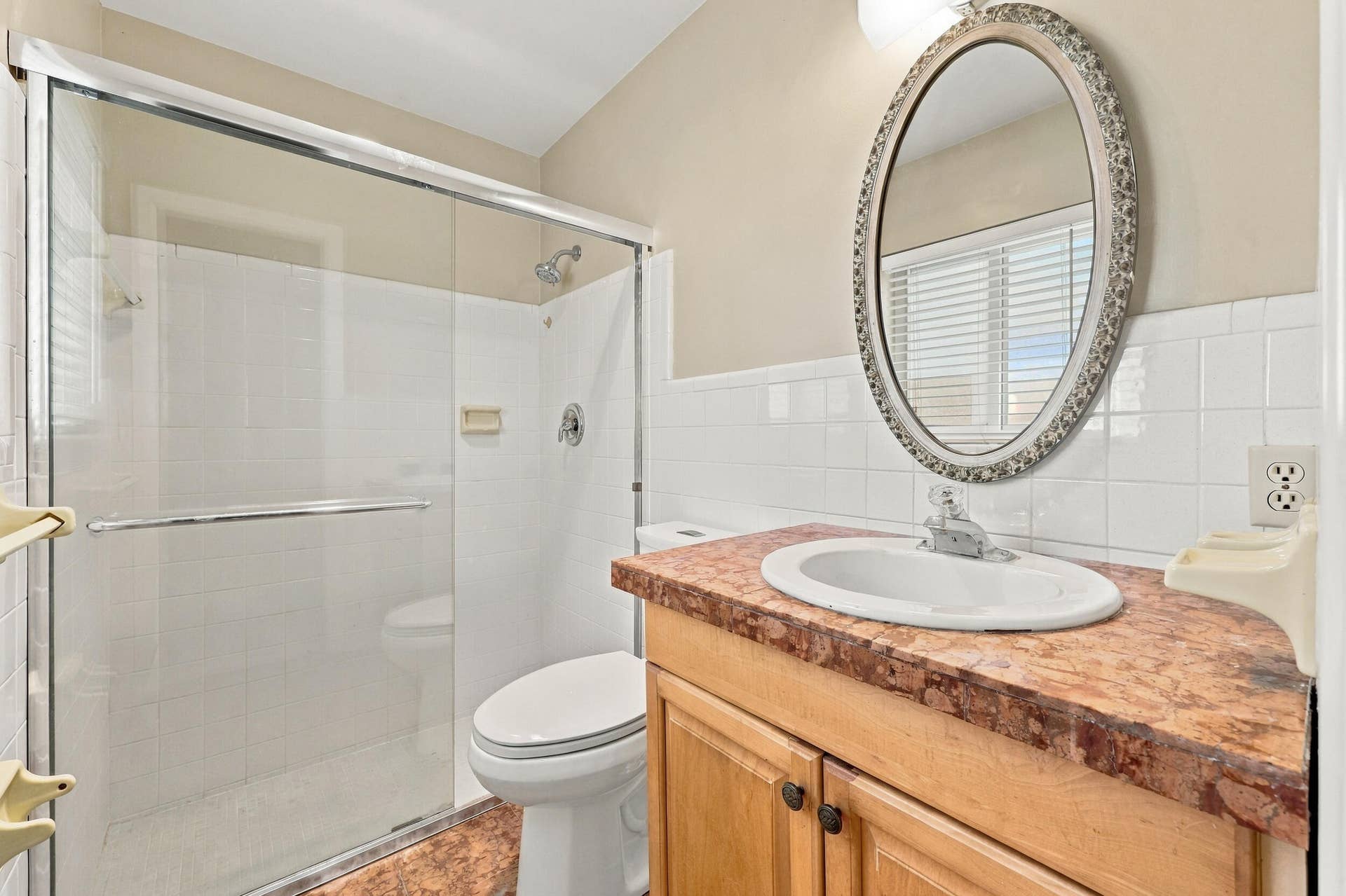 213 NE 24th Court, Boca Raton, FL 33431 The primary ensuite bathroom offers a newly installed glass shower.