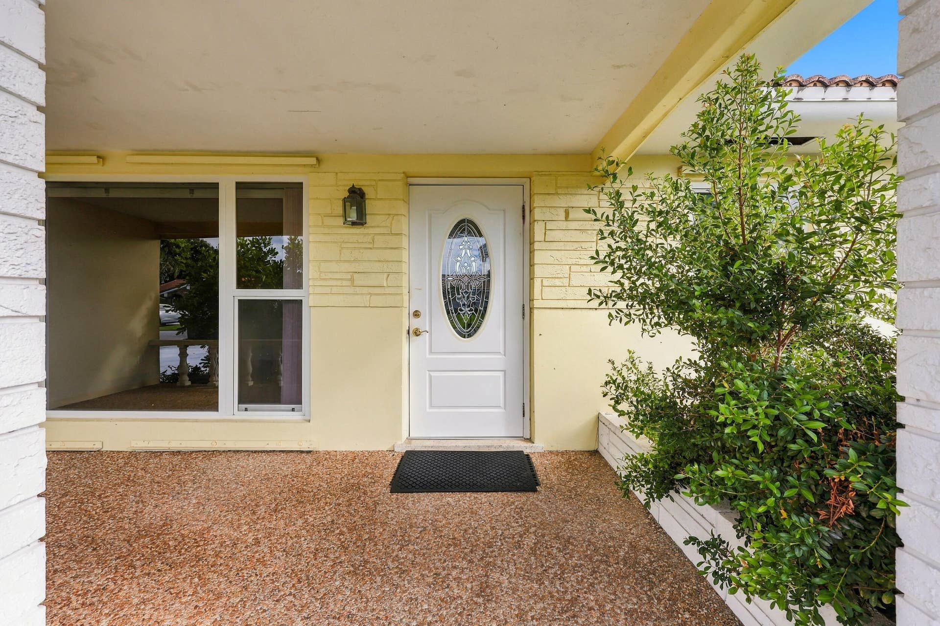 213 NE 24th Court, Boca Raton, FL 33431 The covered front patio is a beautiful place to greet your guests. It features impact windows and a new flat roof.