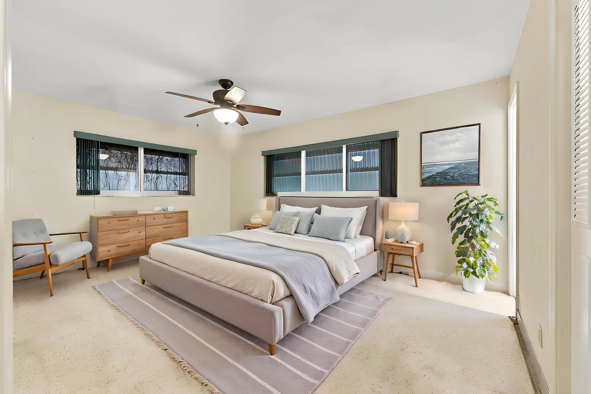 213 NE 24th Court, Boca Raton, FL 33431 The primary bedroom offers lots of natural light through hurricane impact windows. It also offers large closets and an en-suite bathroom.