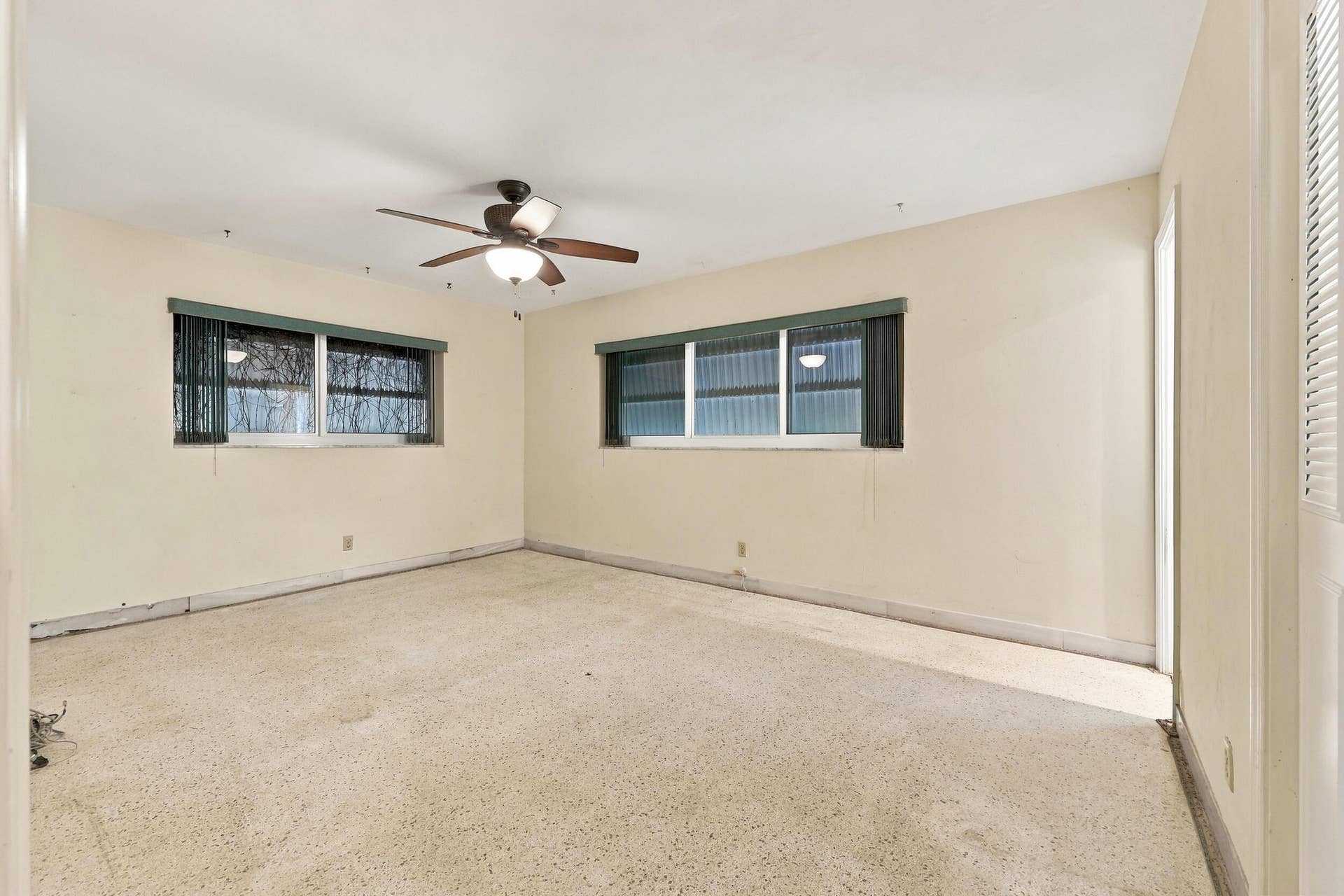 213 NE 24th Court, Boca Raton, FL 33431 The primary bedroom offers lots of natural light through hurricane impact windows. It also offers large closets and an en-suite bathroom.