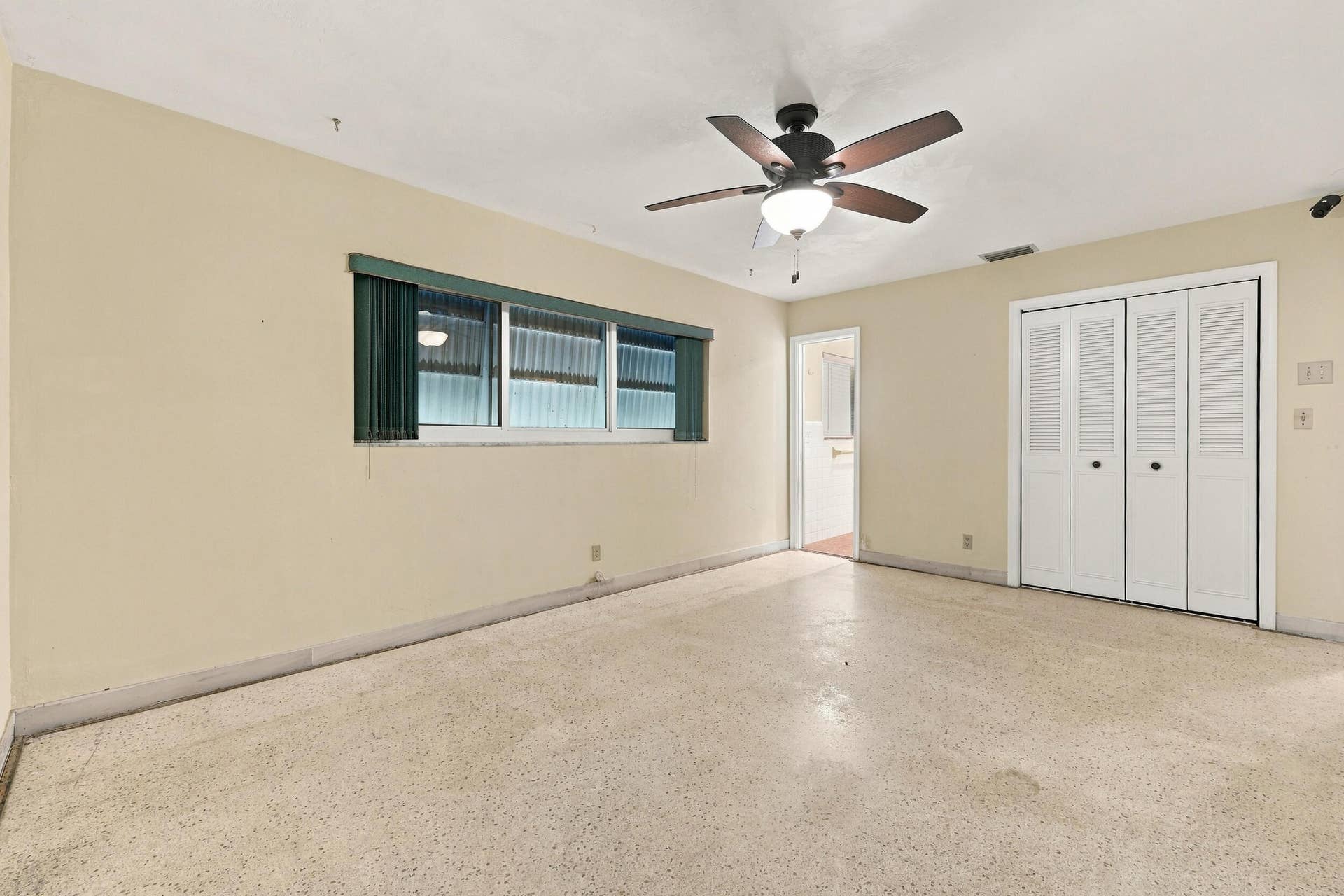 213 NE 24th Court, Boca Raton, FL 33431 The primary bedroom offers lots of natural light through hurricane impact windows. It also offers large closets and an en-suite bathroom.