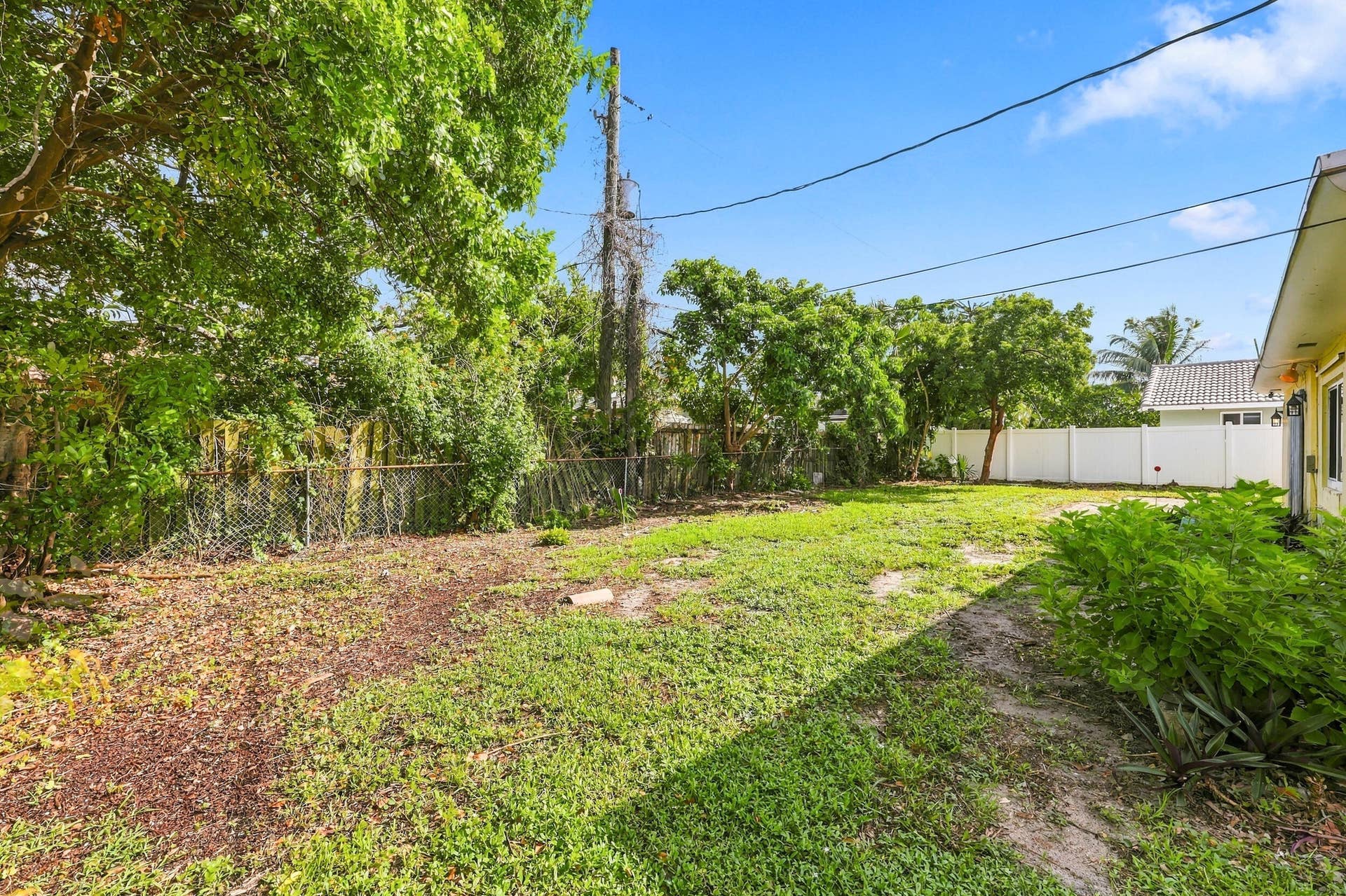 213 NE 24th Court, Boca Raton, FL 33431 The oversized, fully fenced-in backyard offers plenty of room for a pool or an additional space to store all of your toys!