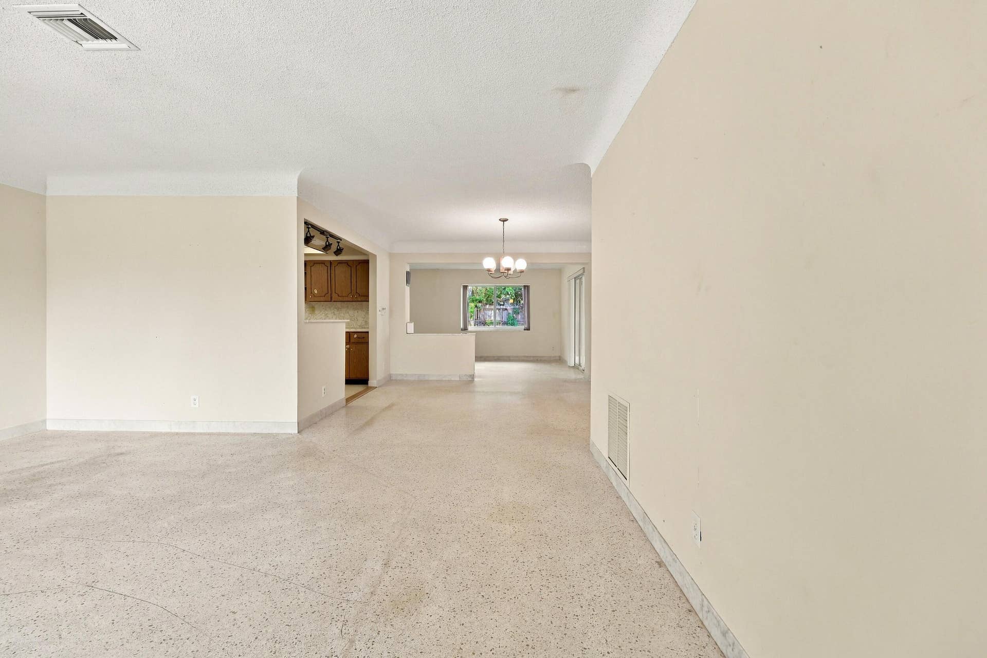 213 NE 24th Court, Boca Raton, FL 33431 As you enter, you are greeted by a large open floor plan and lots of natural light coming through the hurricane impact windows.