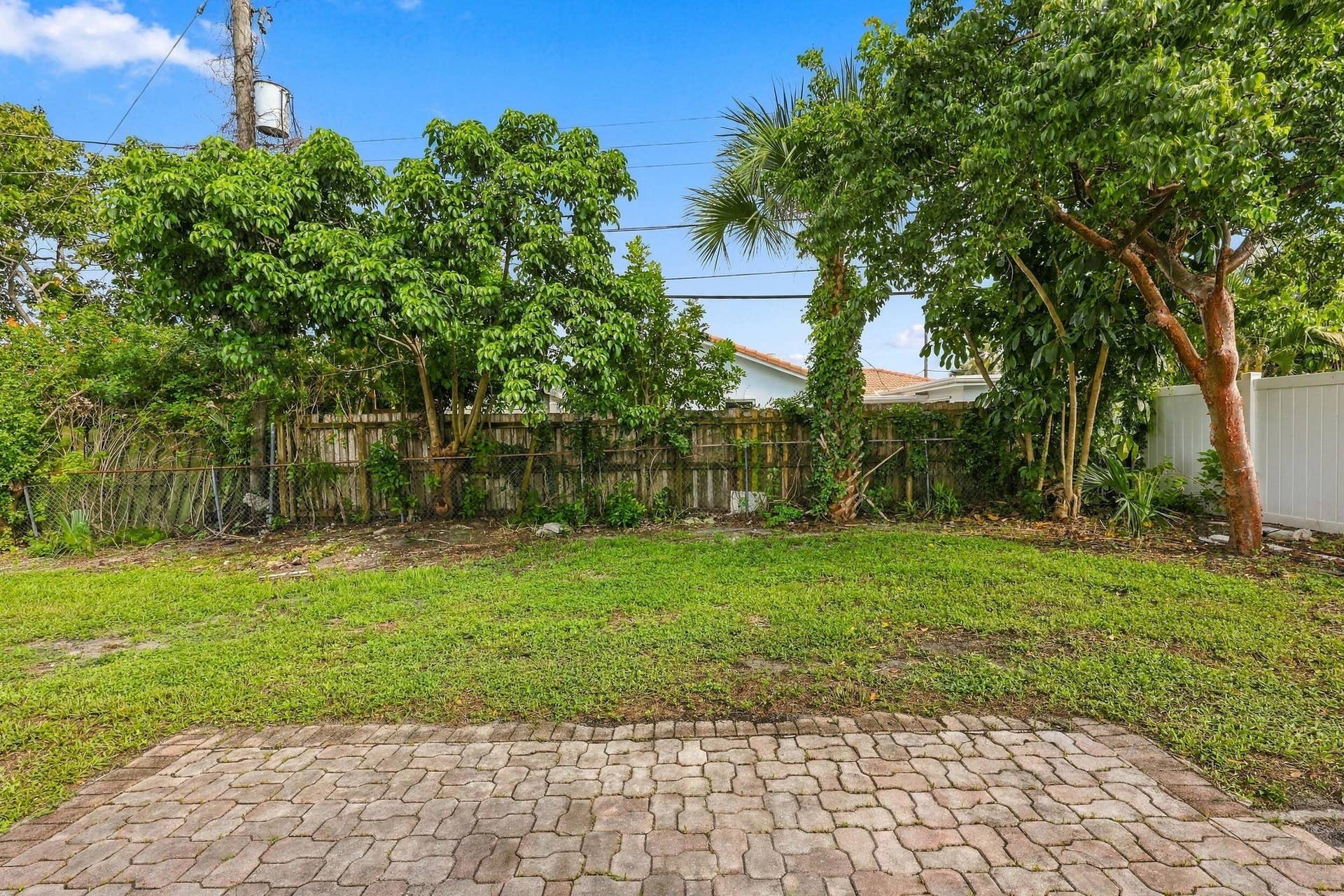 213 NE 24th Court, Boca Raton, FL 33431 The oversized, fully fenced-in backyard offers plenty of room for a pool or an additional space to store all of your toys!