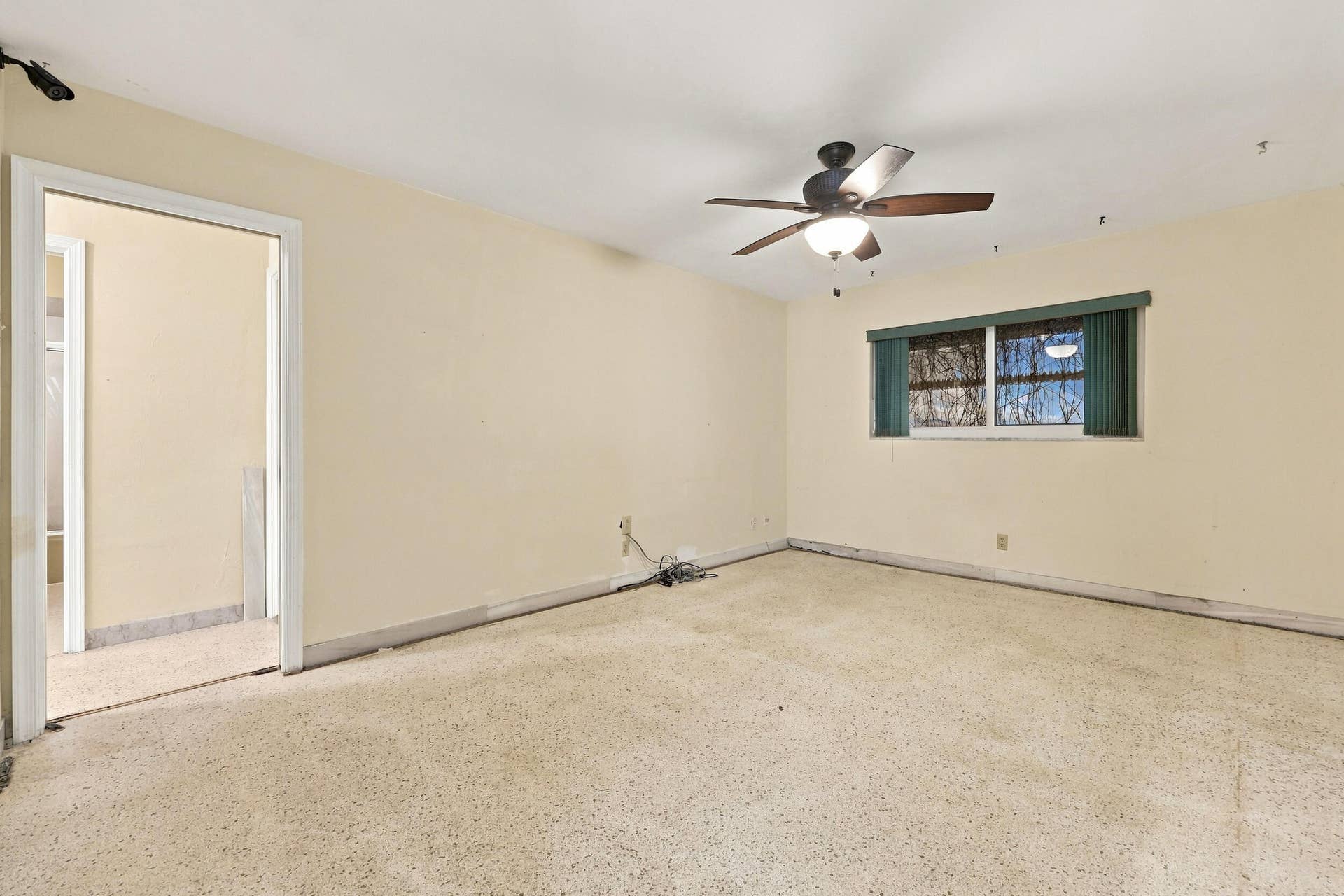 213 NE 24th Court, Boca Raton, FL 33431 The primary bedroom offers lots of natural light through hurricane impact windows. It also offers large closets and an en-suite bathroom.