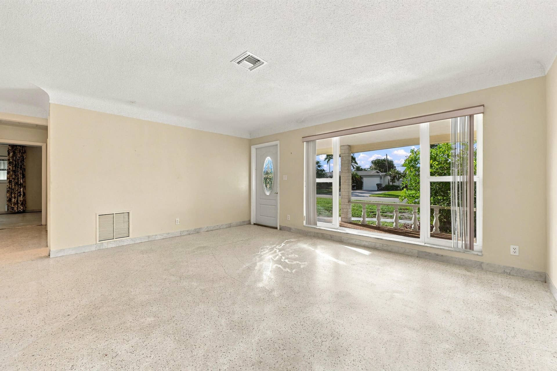 213 NE 24th Court, Boca Raton, FL 33431 As you enter, you are greeted by a large open floor plan and lots of natural light coming through the hurricane impact windows.
