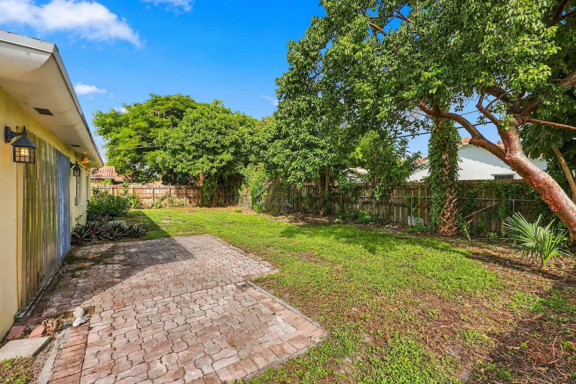 213 NE 24th Court, Boca Raton, FL 33431 The oversized, fully fenced-in backyard offers plenty of room for a pool or an additional space to store all of your toys!
