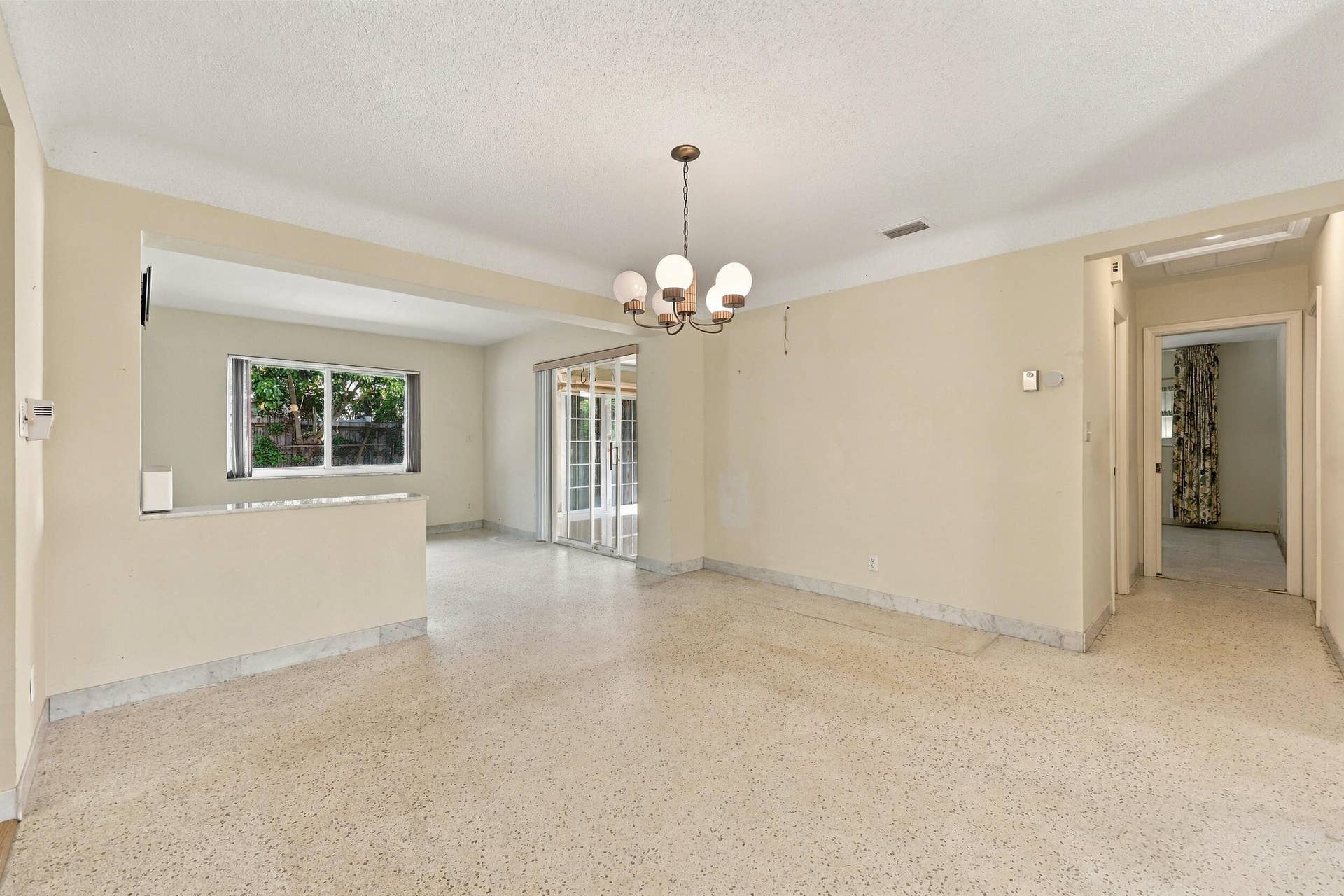 213 NE 24th Court, Boca Raton, FL 33431 As you enter, you are greeted by a large open floor plan and lots of natural light coming through the hurricane impact windows.