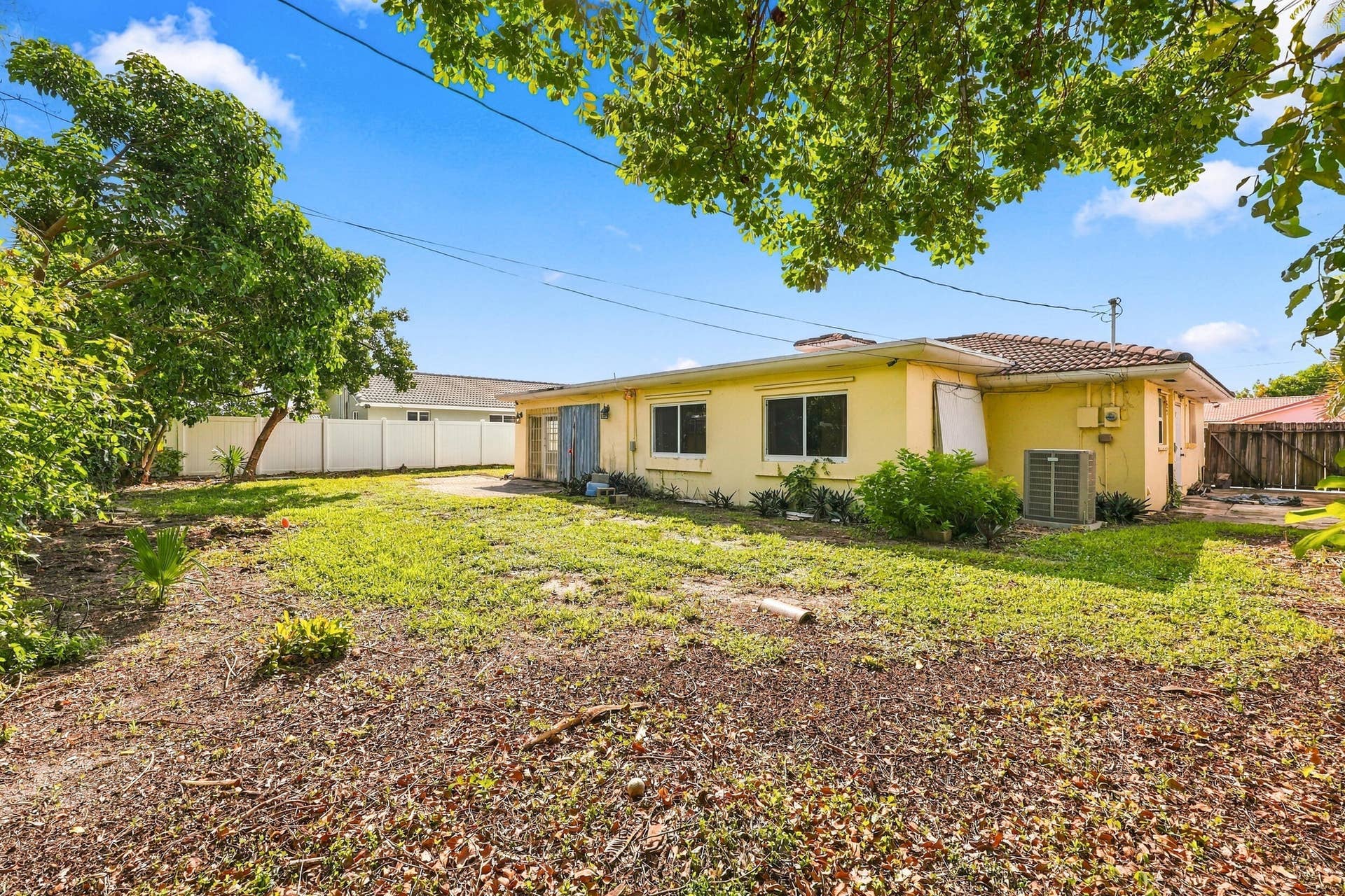 213 NE 24th Court, Boca Raton, FL 33431 The oversized, fully fenced-in backyard offers plenty of room for a pool or an additional space to store all of your toys!