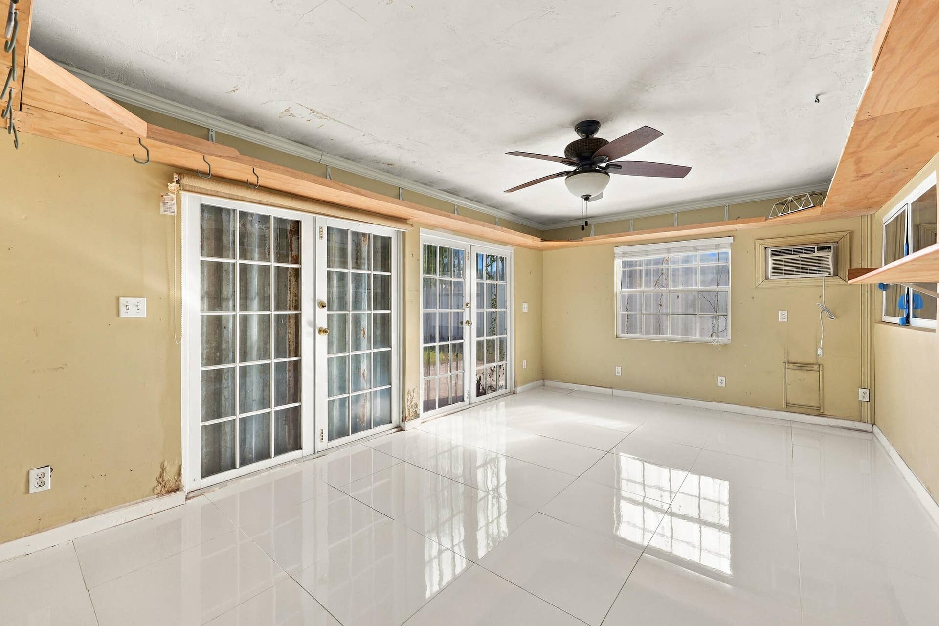 213 NE 24th Court, Boca Raton, FL 33431 The sunroom offers a third living space with quick access to the fully fenced-in backyard.