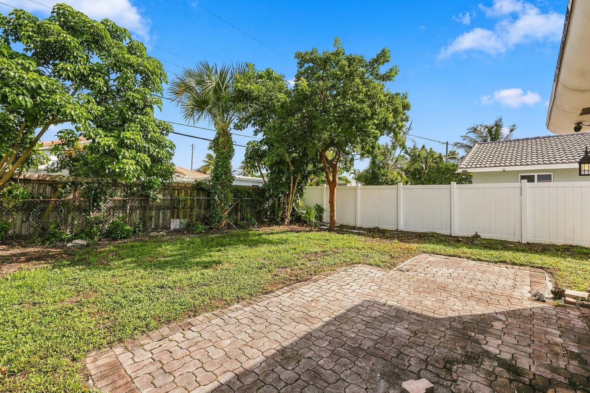 213 NE 24th Court, Boca Raton, FL 33431 The oversized, fully fenced-in backyard offers plenty of room for a pool or an additional space to store all of your toys!