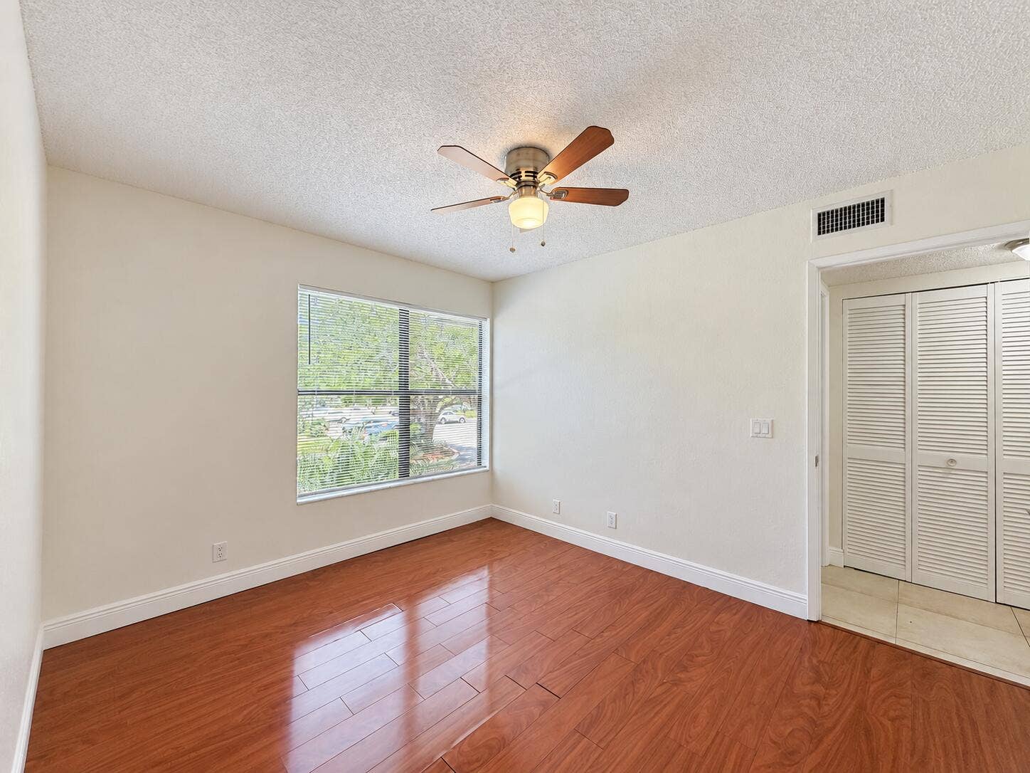 Bright Empty Bedroom with Wood Floors