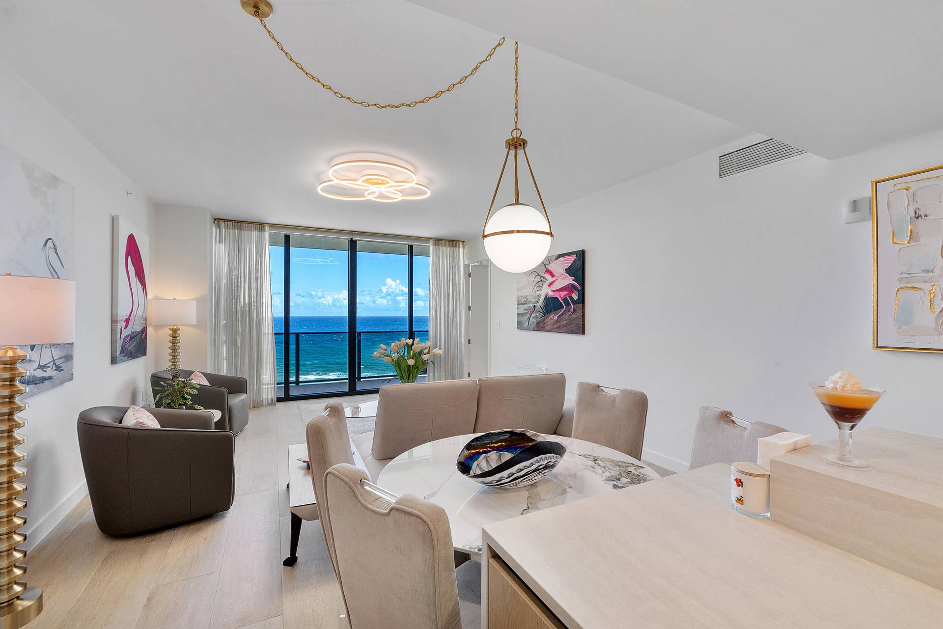 900 N OCEAN Boulevard, #1204, Pompano Beach, FL 33062 Dine in style while enjoying captivating Atlantic Ocean views. This beautifully designed dining area combines contemporary elegance with coastal sophistication, featuring an inviting atmosphere, abundant natural light, and a picturesque ocean backdrop. Perfect for intimate dinners, morning coffee, or entertaining guests.