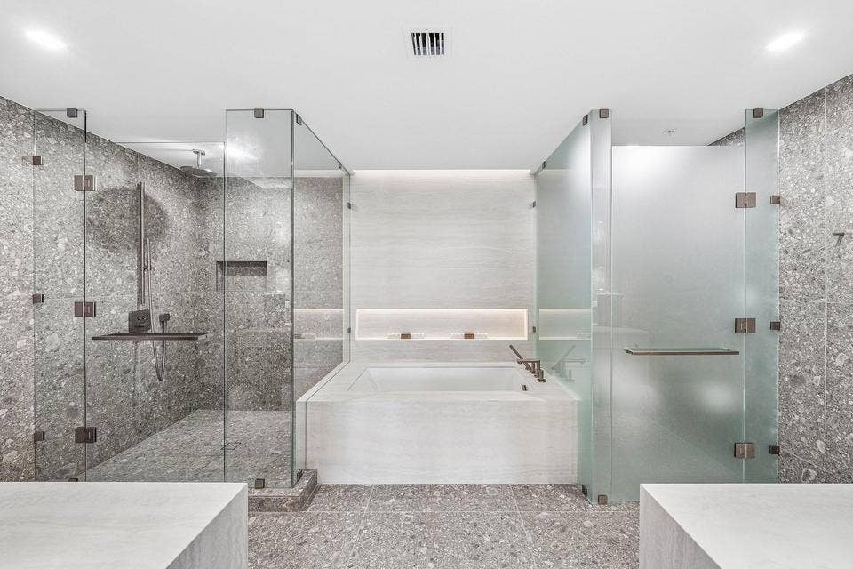 900 N OCEAN Boulevard, #1204, Pompano Beach, FL 33062 A luxurious spa-like sanctuary showcasing sleek contemporary cabinetry, expansive mirrors, a freestanding soaking tub, and beautifully coordinated designer finishes.