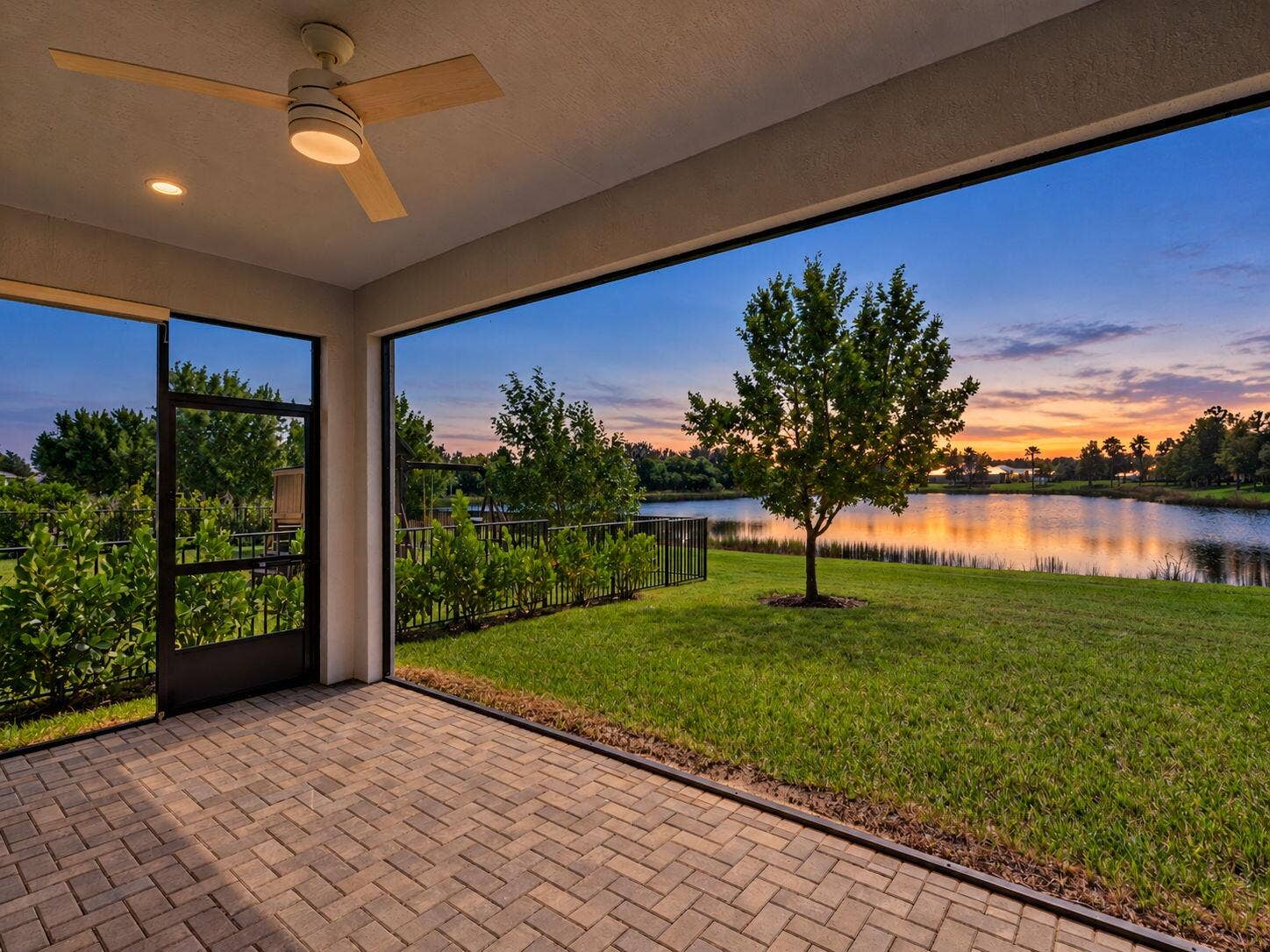 12688 SW Eleanor Drive, Port St Lucie, FL 34987 Covered screened-in patio featuring brick paver flooring, recessed lighting, and a modern ceiling fan
