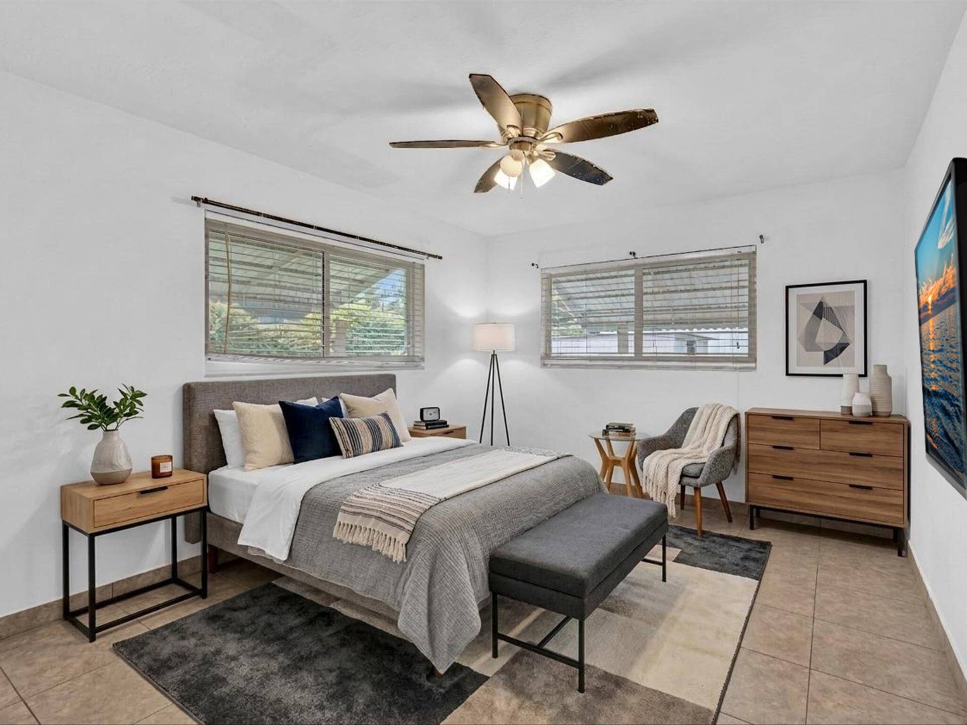 132 SE 2ND Court, Dania Beach, Dania Beach, FL 33004 Neutral-toned space featuring large dual-pane windows, tile flooring, and a ceiling fan with integrated lighting