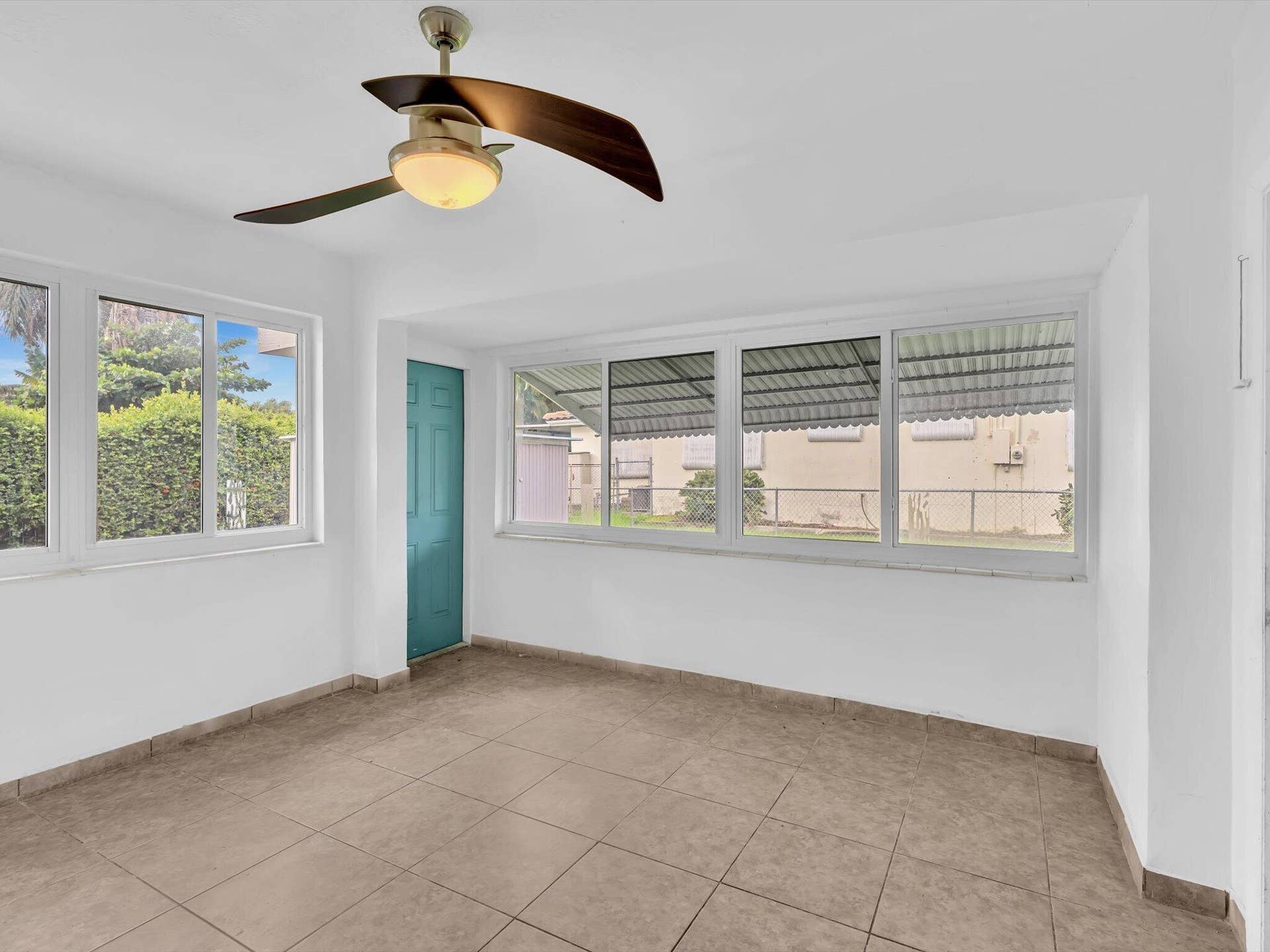 132 SE 2ND Court, Dania Beach, Dania Beach, FL 33004 Interior space featuring large windows, ceramic tile flooring, and a ceiling fan with integrated light fixture