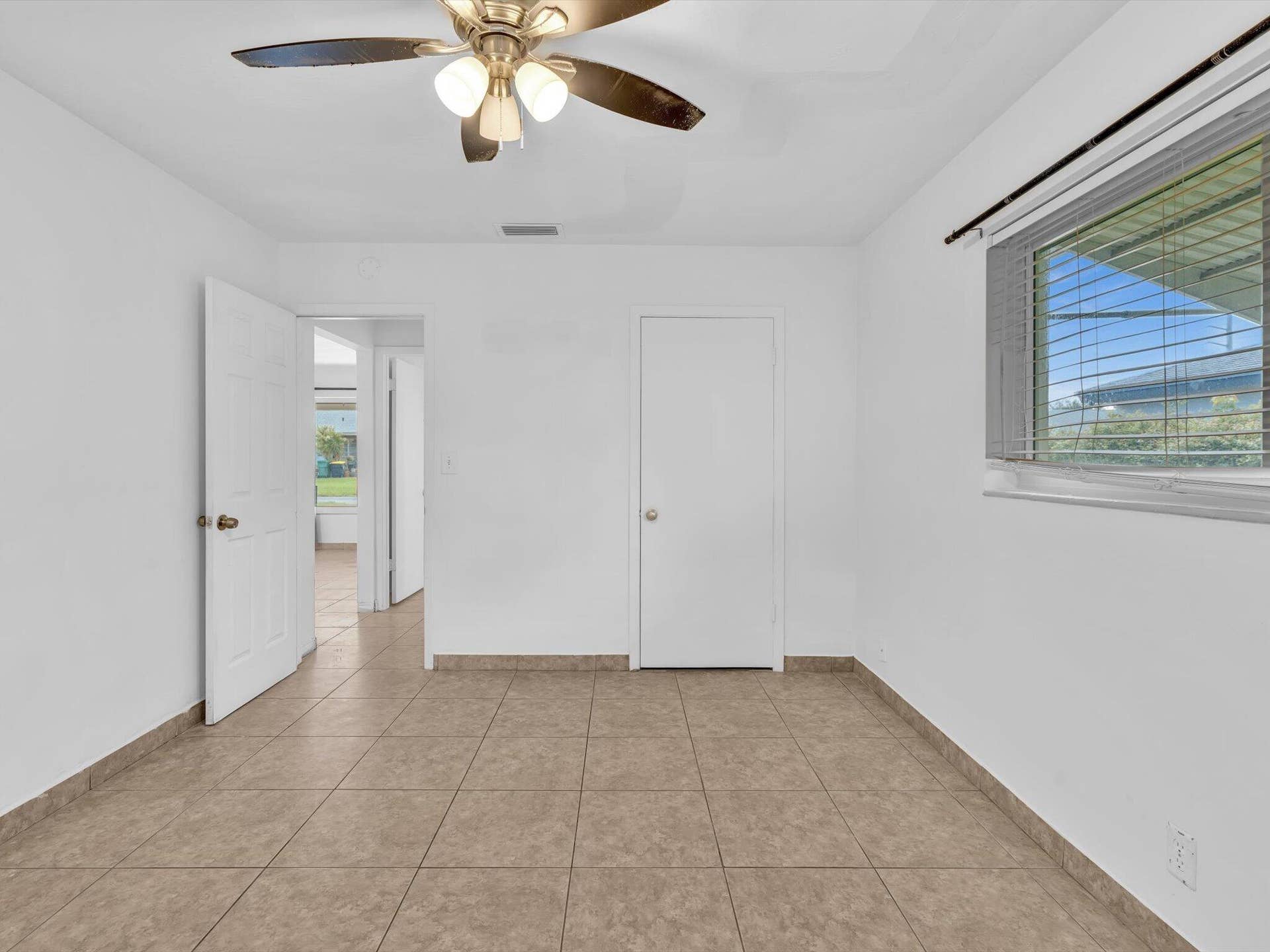132 SE 2ND Court, Dania Beach, Dania Beach, FL 33004 Neutral-toned tile flooring, ceiling fan with integrated lighting, and window featuring horizontal blinds